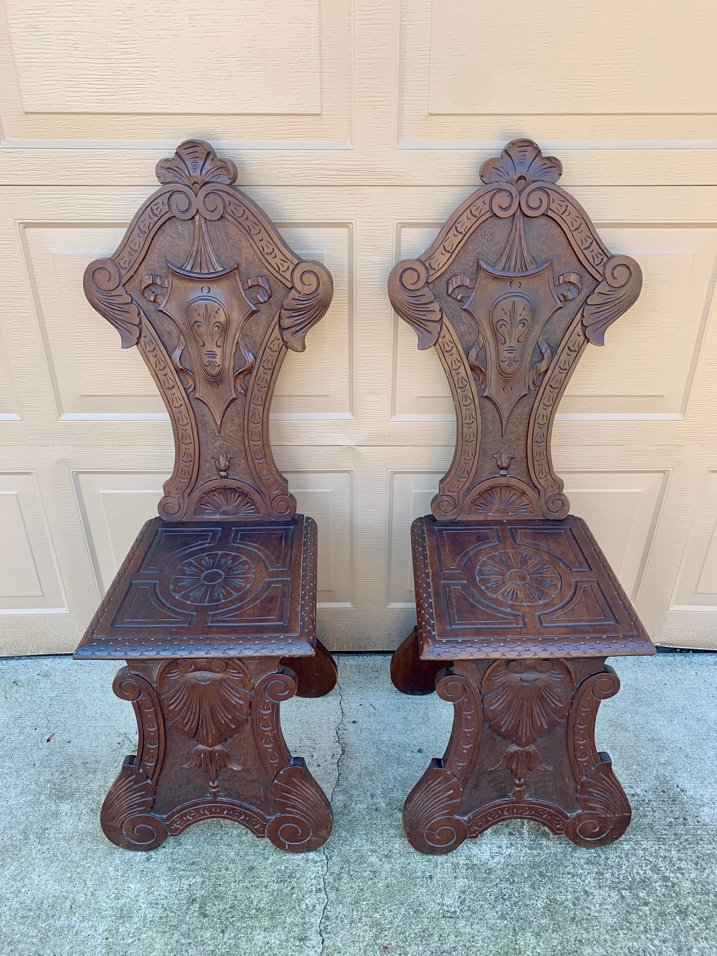 A stunning pair of antique Italian Renaissance hand carved walnut hall chairs 

Italy, Circa Mid-19th Century

Measures: 16.5