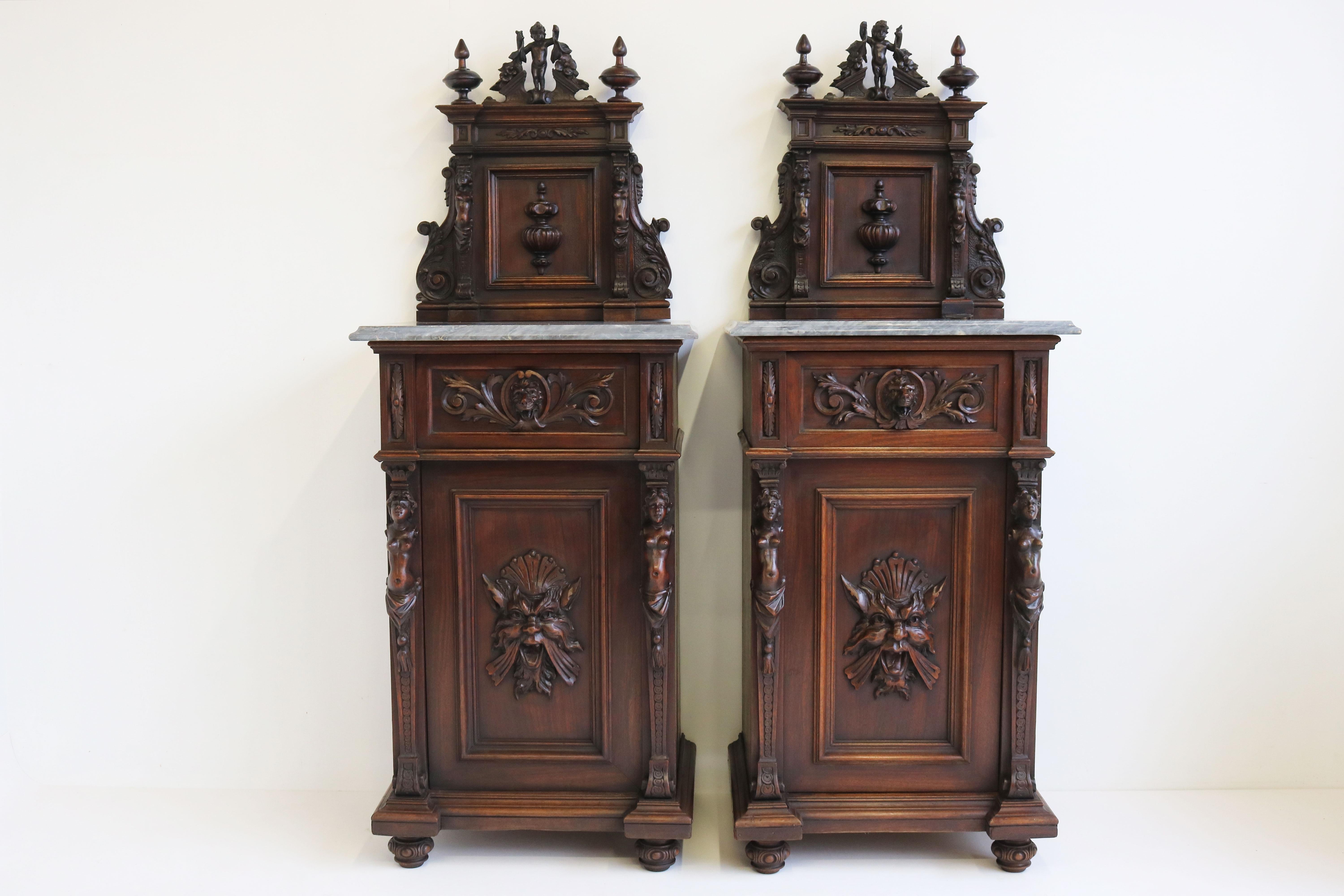 Exquisite & breathtaking! This pair of Italian Renaissance bedside tables richly carved with ''Emperador grey'' marble tops. 
Unique pair displaying various wood sculptures like cherubs, woman, lions & demons. 
What makes these bedside tables even