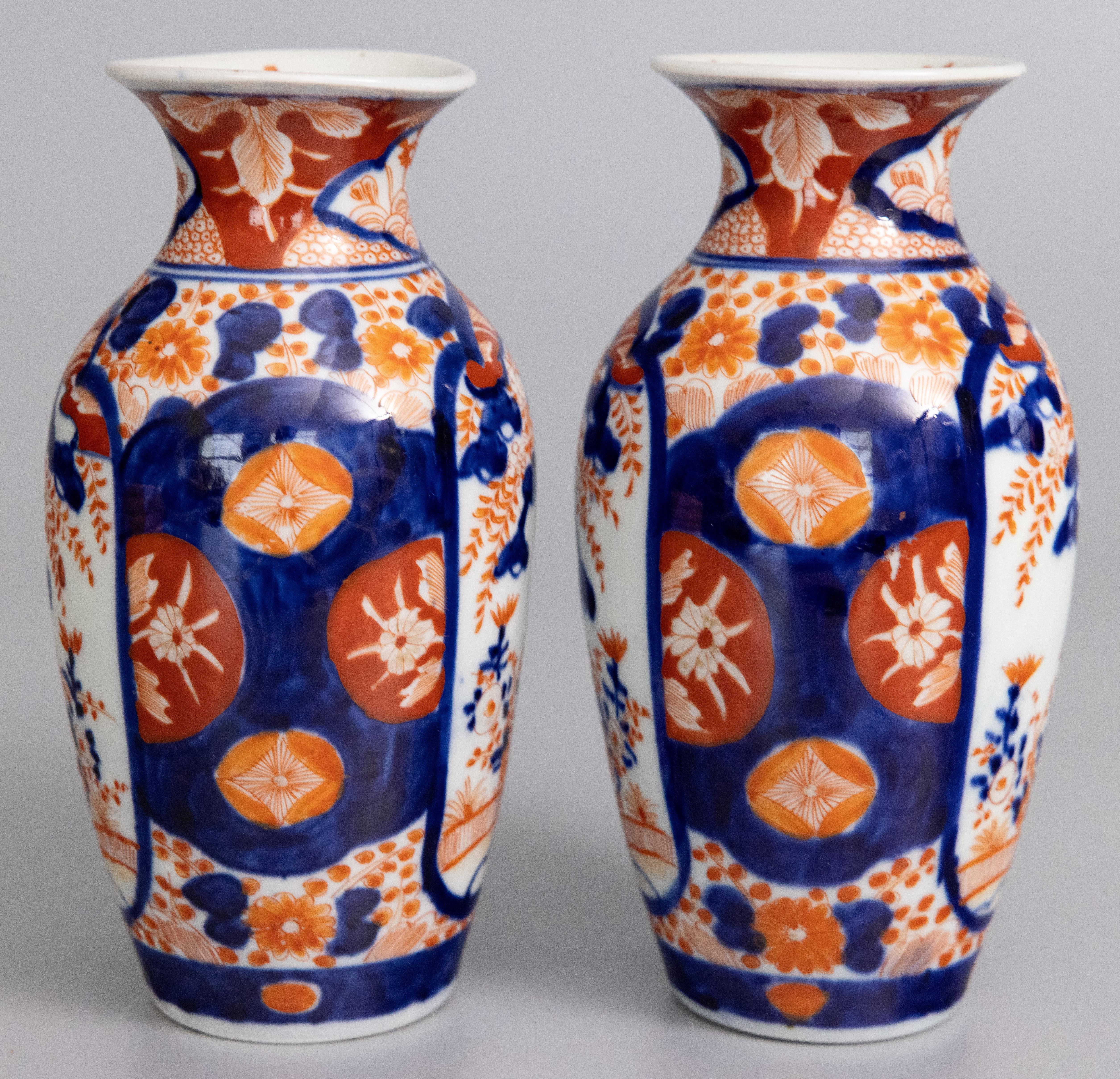 A handsome pair of 19th-Century Japanese Imari porcelain vases. These fine vases have a lovely shape and hand painted floral designs in the traditional Imari colors. 