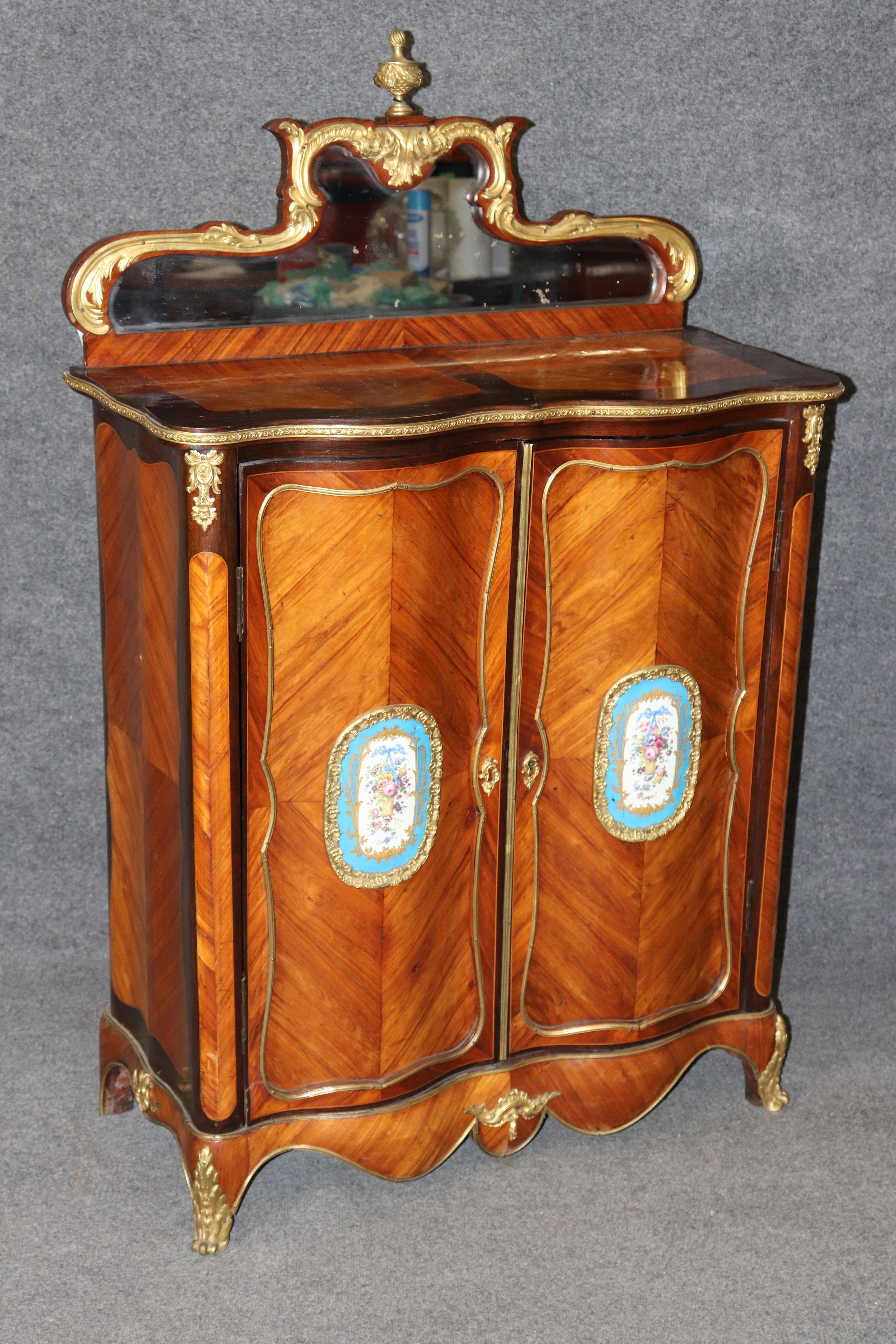 Dimensions - H : 53 in W : 34 po D : 16 1/4 po 

Cet exquis meuble ou serveur de style Louis XV français du XIXe siècle est un chef-d'œuvre de luxe, d'élégance et de finesse d'exécution, mettant en valeur le raffinement artistique qui définissait