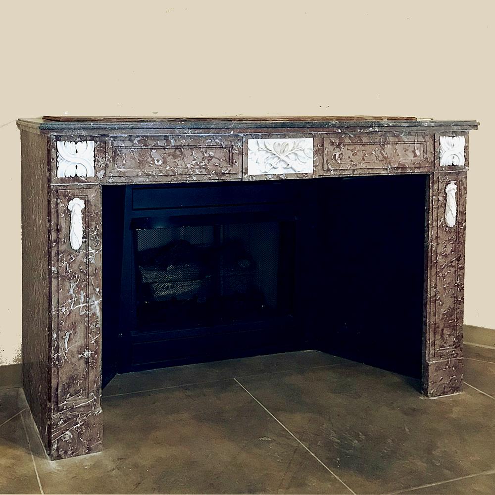 Antique 19th century Louis XVI French Rouge and Carrara marble fireplace mantel. Beautifully veined marble fireplace mantel creates a focal point in any room. Clean, tailored contours allow this piece to complement virtually any decor, while the