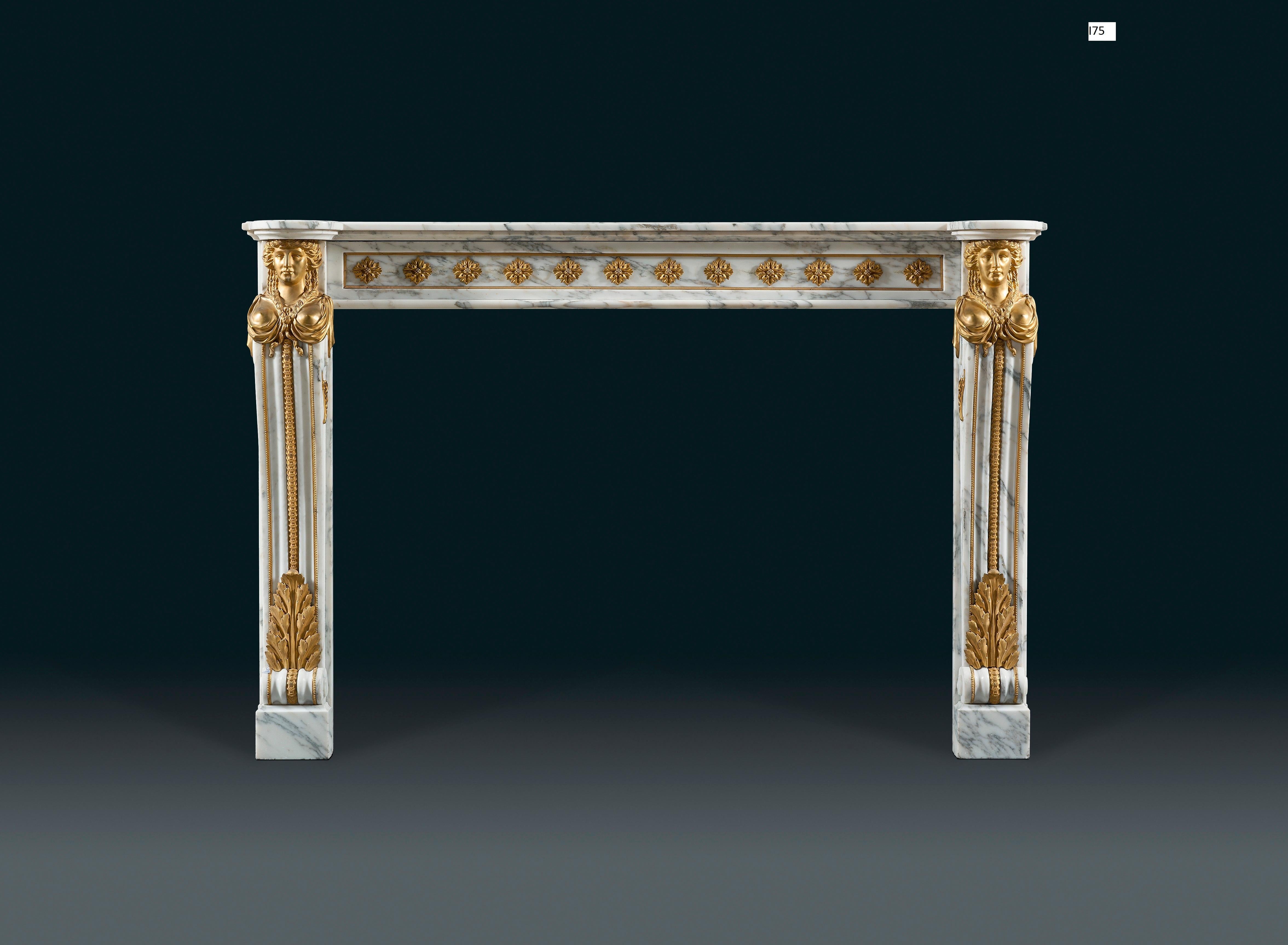 A 19th century, Louis XVI style chimneypiece in veined statuary marble with impressive and well-cast gilt bronze mounts. The rectangular shelf with rounded ends. The frieze with well-cast ormolu flower heads applied to the marble frame, the console
