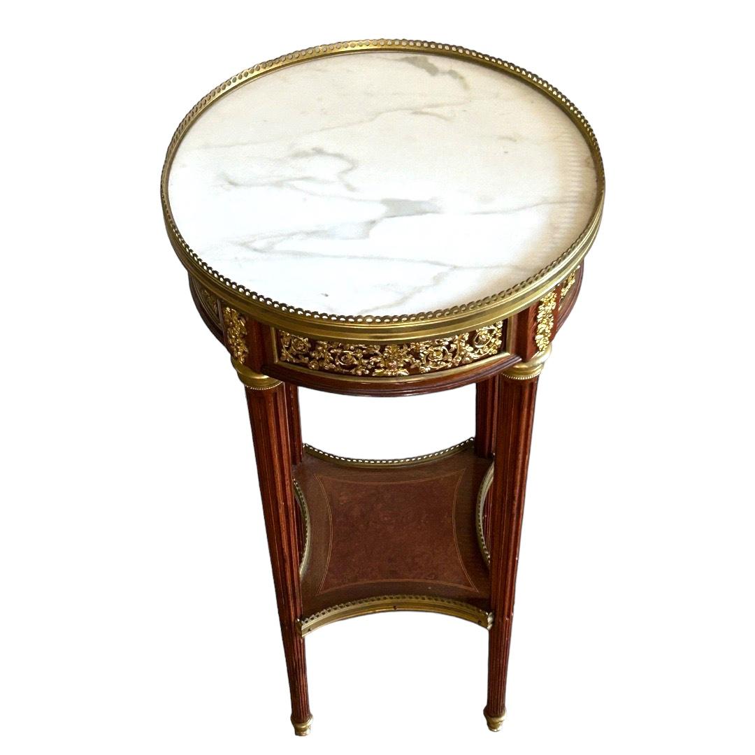 Crafted by Millet of Paris in mid 1800s, exquisite ornate detailed wood/marble/brass side table; inset veined cream marble top with pierced brass edge; single drawer along with 4 tapering legs with joined burl lower shelf and brass feet; Baroque