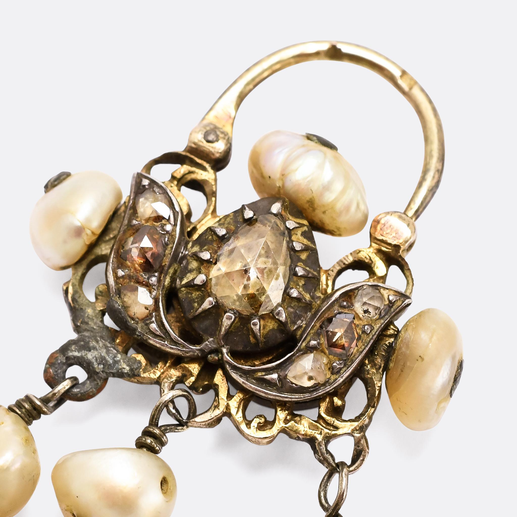 An incredible pair of earrings made in the Maghreb region of North Africa during the latter half of the 19th century. They're lavishly adorned with baroque pearls (12 good sized stones per ear) and rose cut diamonds, set in ribbon like branches