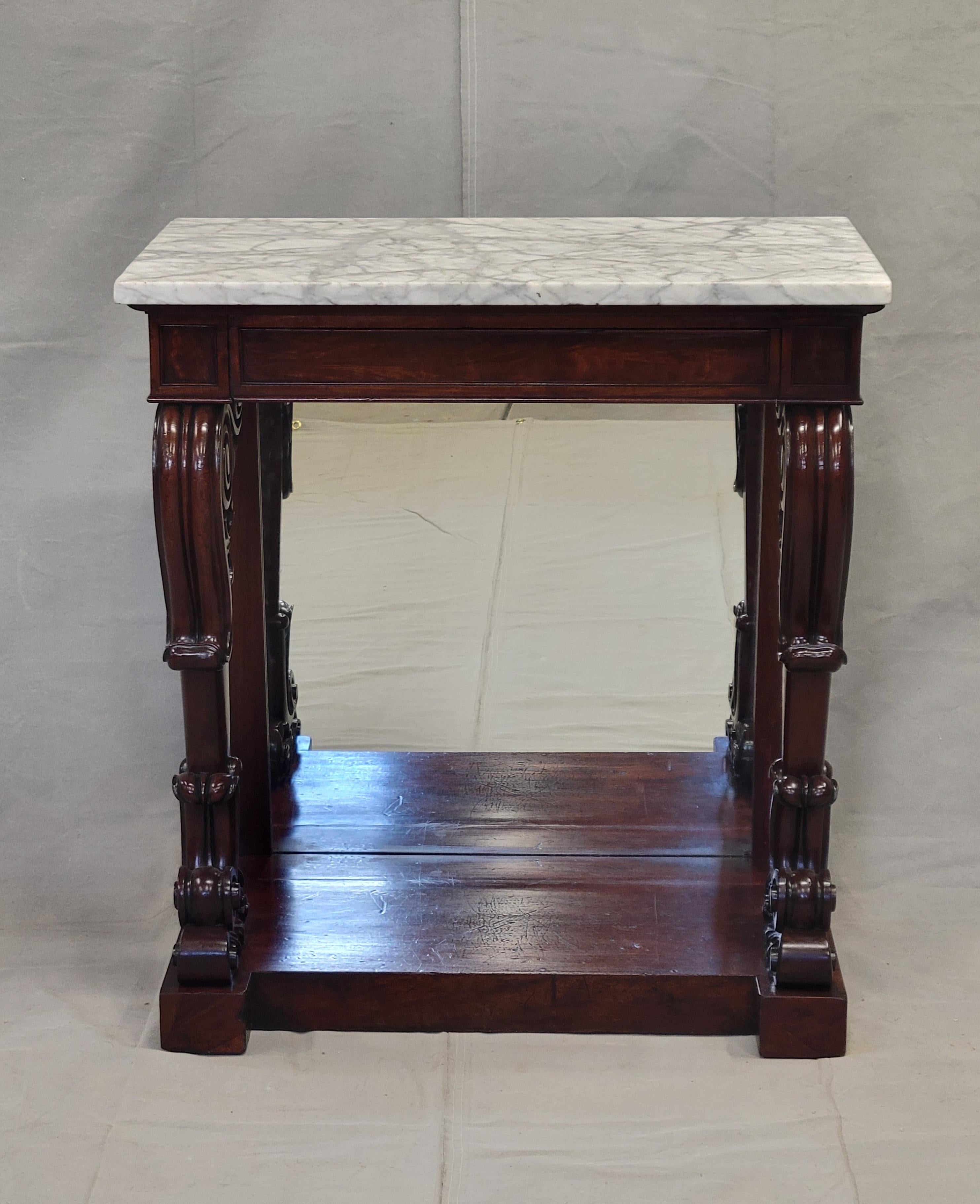 This antique console table is a stunning piece of furniture that will add character to any room. Crafted from mahogany and marble, this table exudes elegance and sophistication. The polished finish and honed Carrara marble give it a timeless appeal.