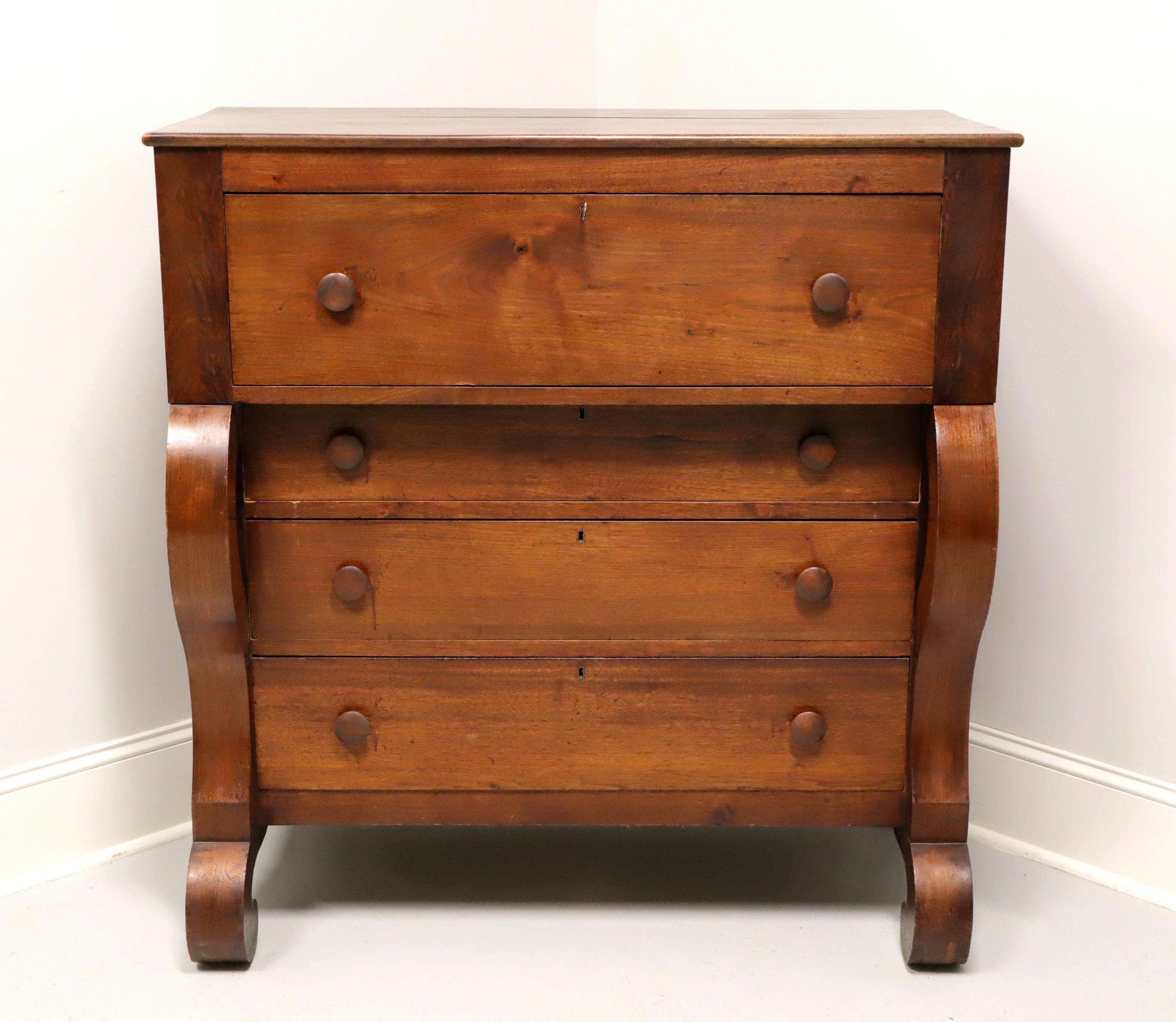 An antique Empire style chest of drawers, unbranded. Solid mahogany with classic Empire styling, with curved outward sides and curved back front feet. Features four drawers of dovetail construction with wooden knobs and locks. Includes one key. Made