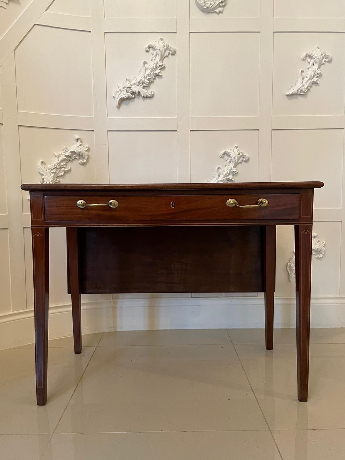 Antique 19th century George III inlaid mahogany drop leaf side table having a marvelous mahogany top with a drop leaf, one long drawer with pretty inlay and original brass handles. It stands on two inlaid square tapering legs to the front and two