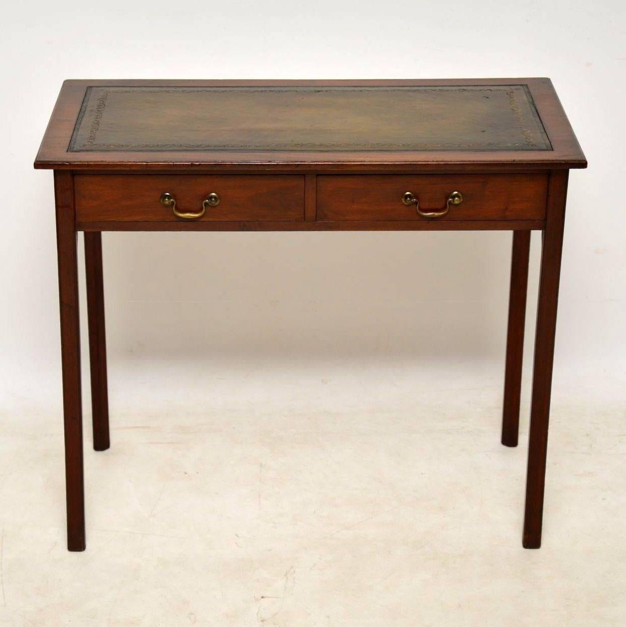 This antique leather top mahogany writing table is a very elegant piece and it's in excellent condition. It looks original Georgian and the drawers are finely dovetailed, with original brass handles. The leather writing surface has a lovely color