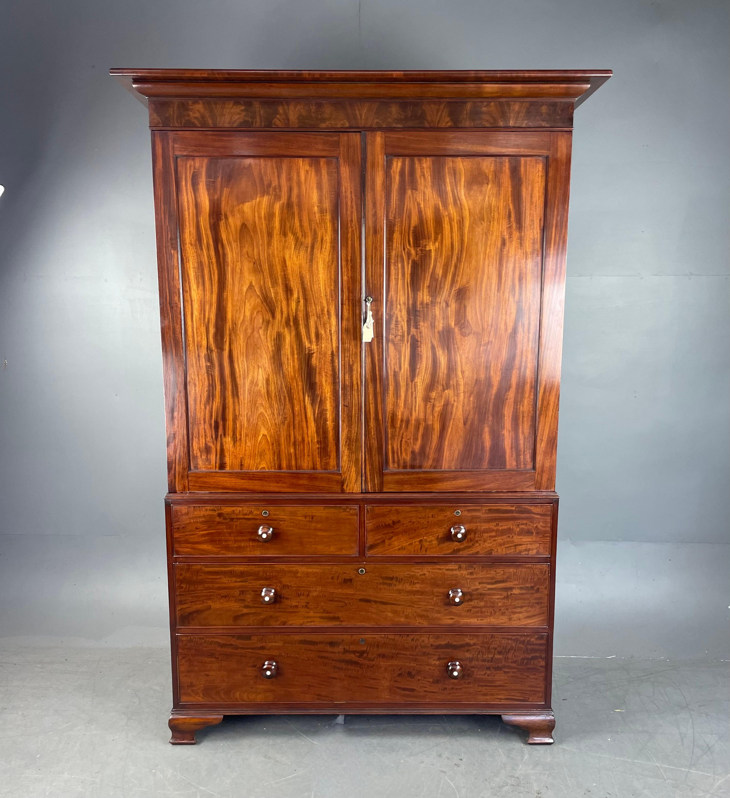 Fine Quality early 19th century flame mahogany linen press /wardrobe .
The press is in very good original condition having been professionally cleaned and traditionally waxed finished to maintain the fantastic colour and grain of the fine figured