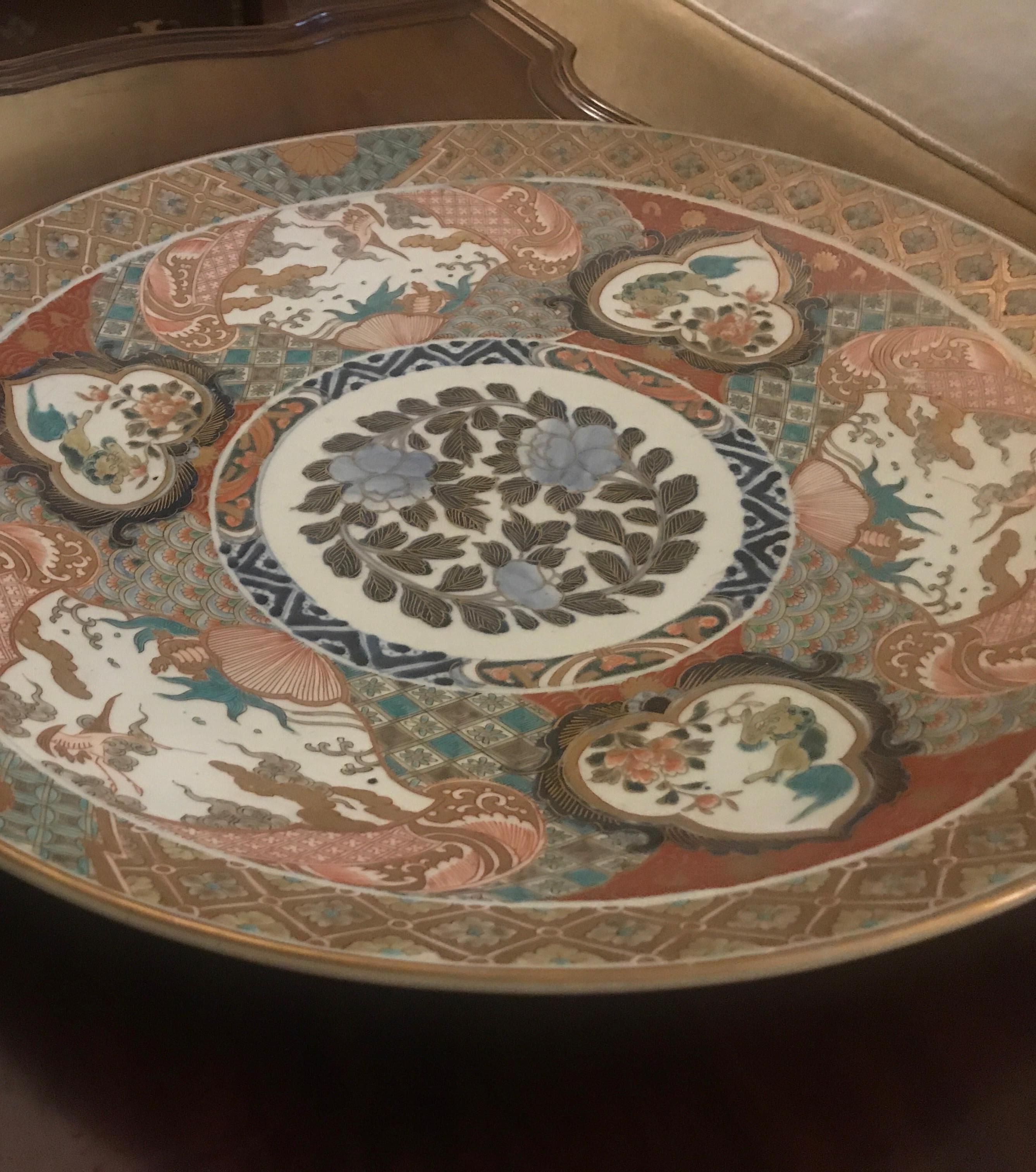 Large 18 inch diameter hand painted Imari Japanese porcelain charger. The detailed hand painted decoration with classic iron red, cobalt blue with gilt accents.