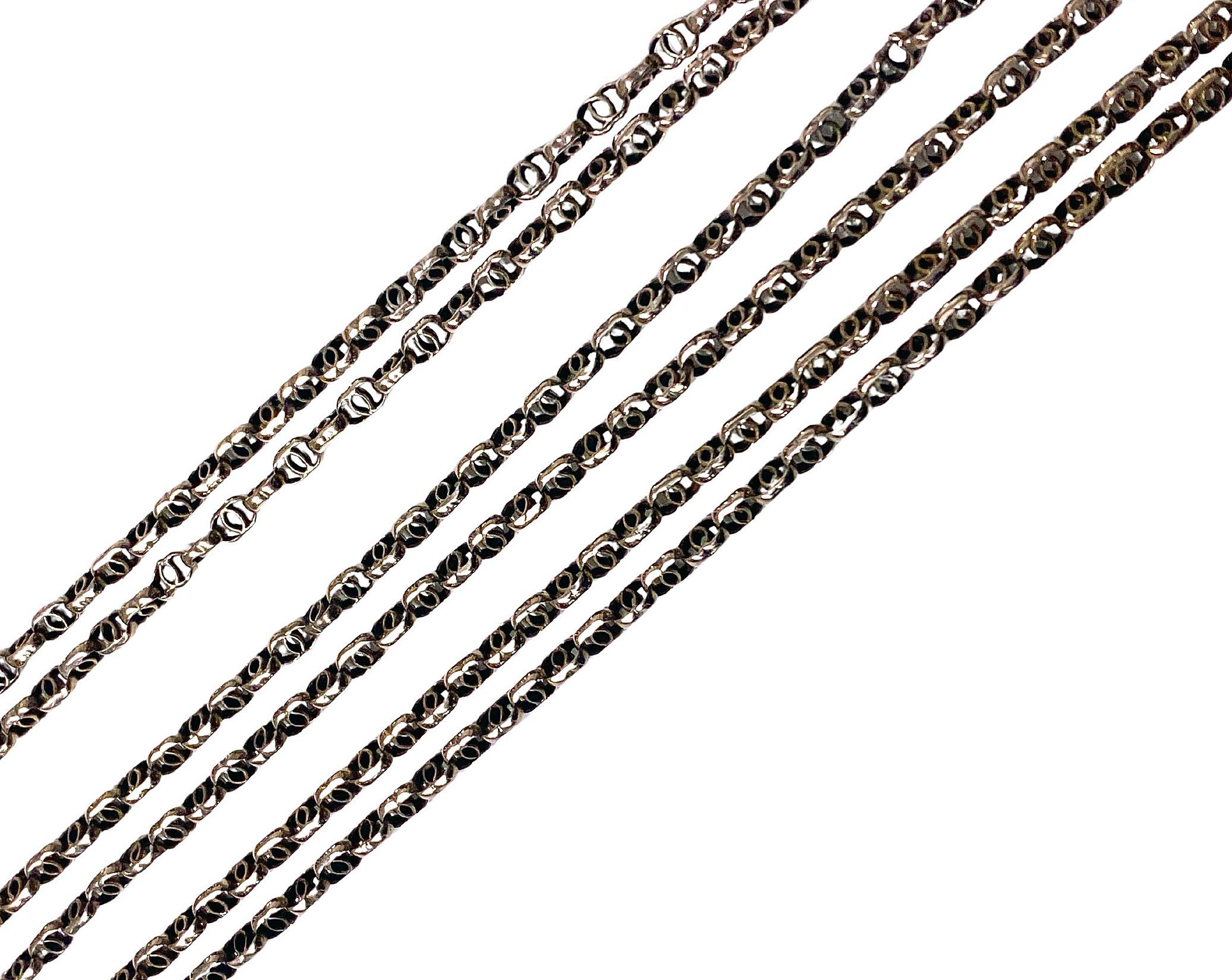 Antique 19th century Muff Chain, English C.1890. The 9ct chain with intertwining open links, suspending gold swivel stamped 9ct. Length approximately: 56 inches. Weight: 19.8 gm.