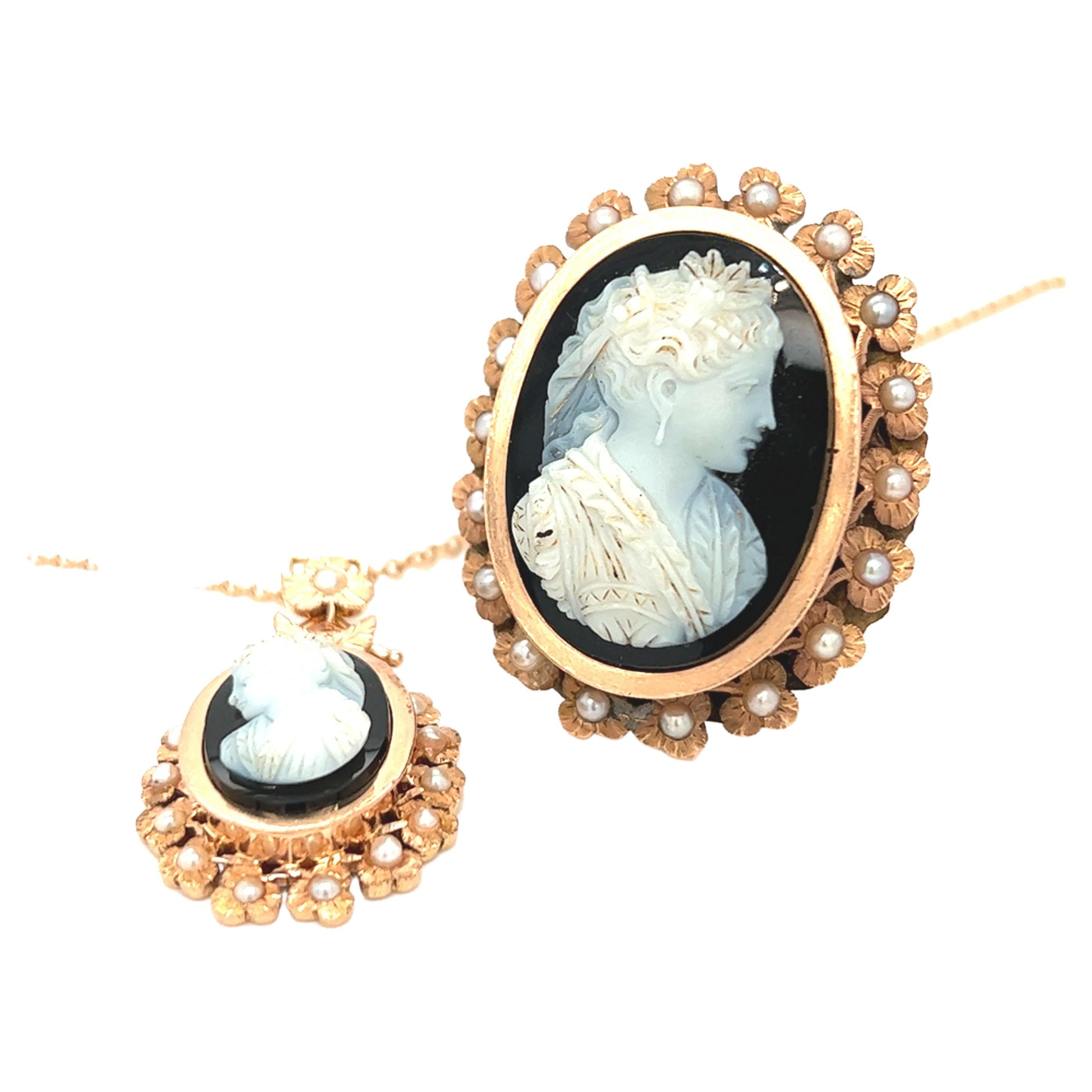 An antique ring and pendant set with a two-layered cameo on onyx,  oval in shape representing the profile of a woman. The ring features a graceful feminine silhouette framed by a captivating halo of three petaled flowers with seed pearl centers.