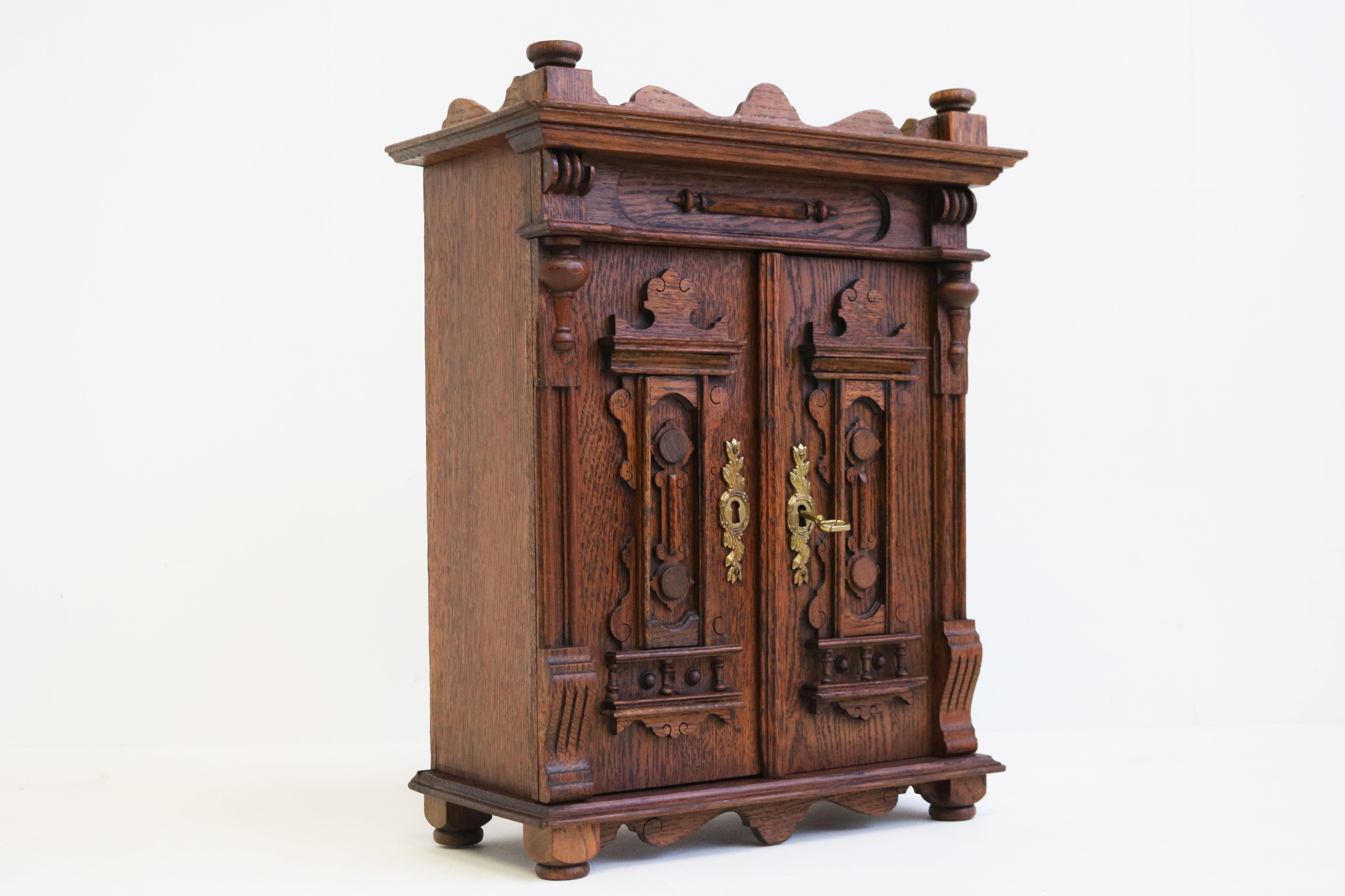 Lovely antique 19th century Neoclassical wall cabinet / small cabinet Germany 1880.
This German Grunderzeit cabinet is made from hand carved oak & is richly decorated. 
A true display of craftsmanship & quality.
This cabinet has 2 doors and comes