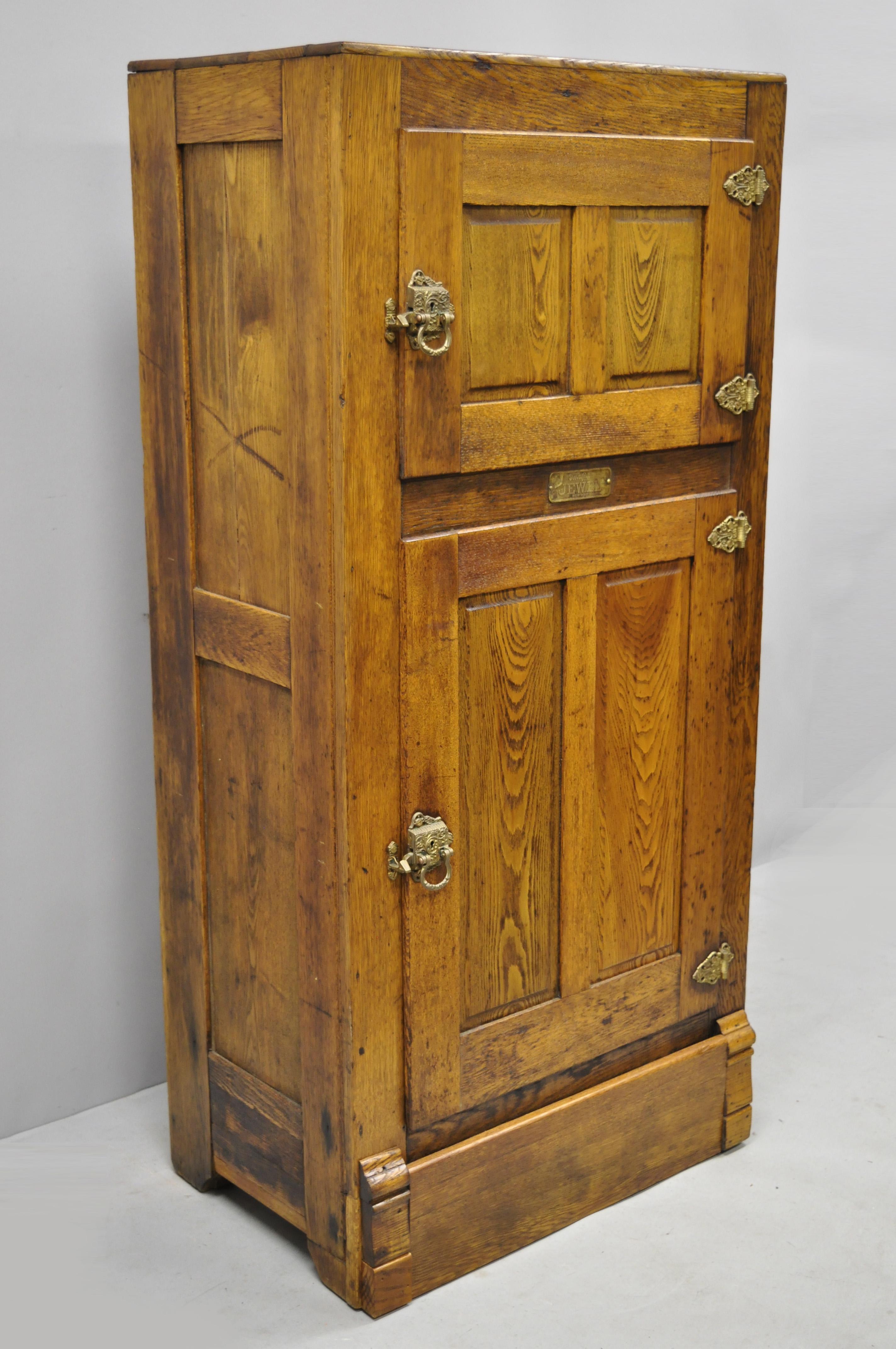 Antique 19th century oakwood two-door ice box freezer by Steinfeld Jewel. Item features 2 swing doors, solid wood construction, beautiful wood grain, original metal tag, solid brass hardware, quality American craftsmanship, circa late 19th century.