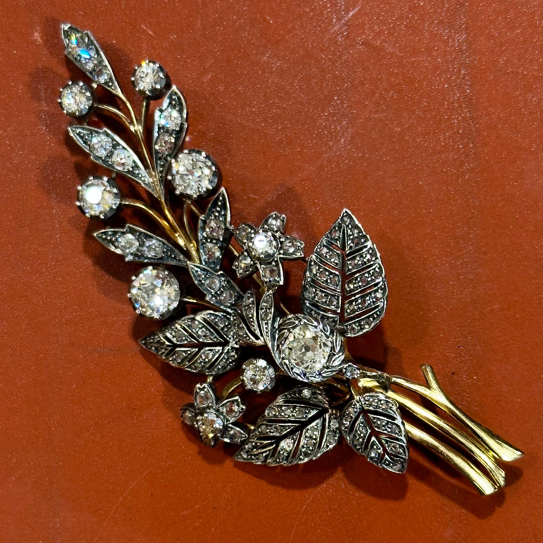Antique Victorian diamond floral spray brooch in silver and yellow gold, probably Portuguese, circa 1890. A dramatic jewel from the second half of the 19th century, modelled as a floral and foliate spray composed by flowerheads and naturalistic
