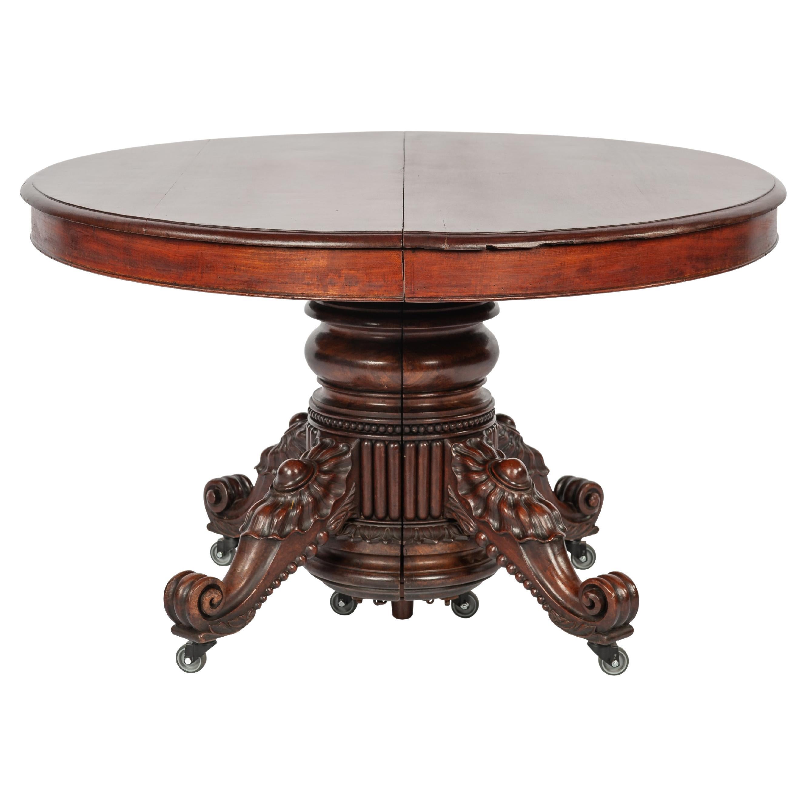 Antique 19th-century oval extendible French warm brown mahogany dining table. For Sale