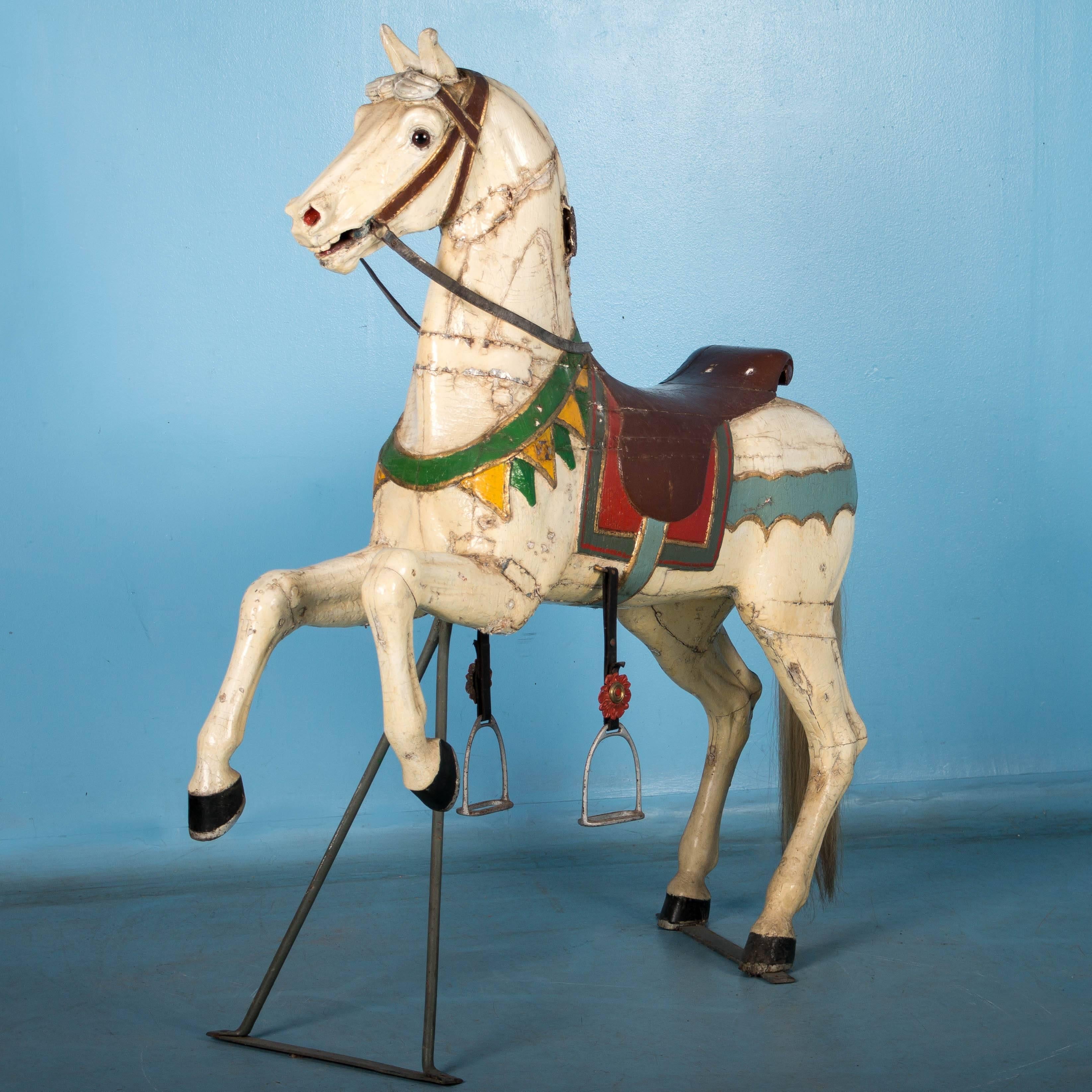 Whimsy and delight of an age gone by exude from this wonderful old carved Tivoli horse from Copenhagen. The age related repairs include the addition of metal bands (see around the neck and right knee) which truly add character to this amazing