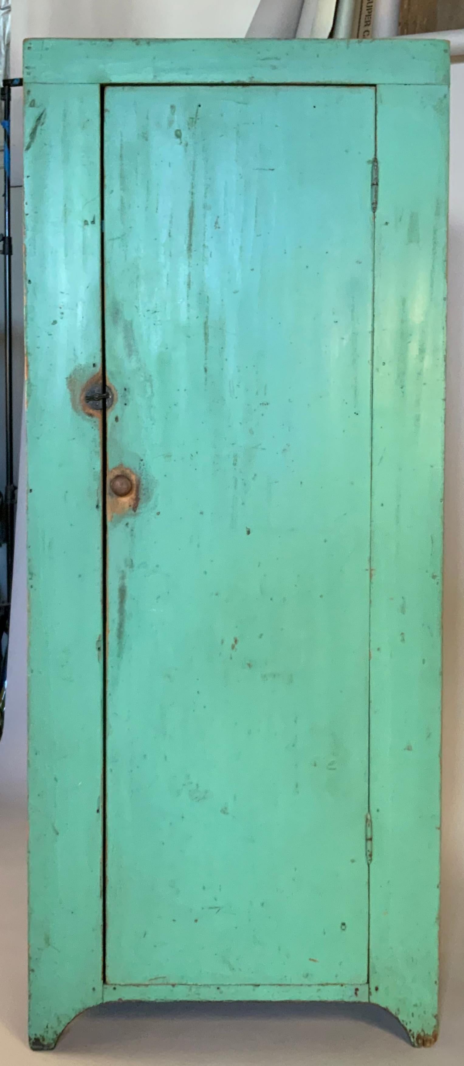 A very charming antique 19th century hand painted cupboard, in its original paris green painted finish, with a hinged door and an interior fitted with cubbies and shelves. beautiful scale and very well made. wonderful color!.