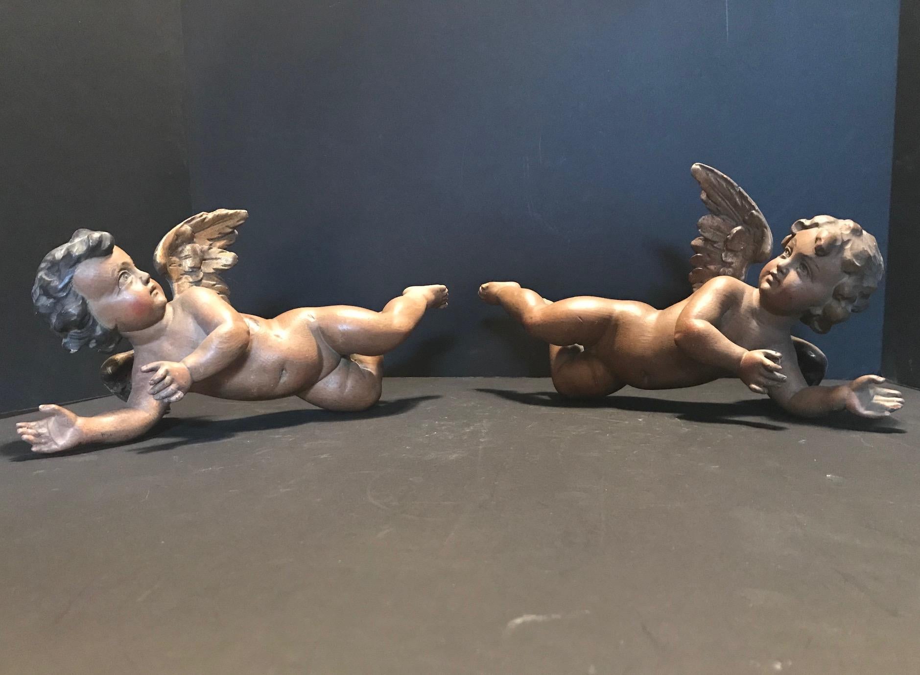 This beautiful pair of putti is artistically polychromed with gilded wings. The carving
is masterfully done with perfect anatomical proportions and details. They are an
important set of putti for connoisseurs.
Appropriate signs of wear consistent