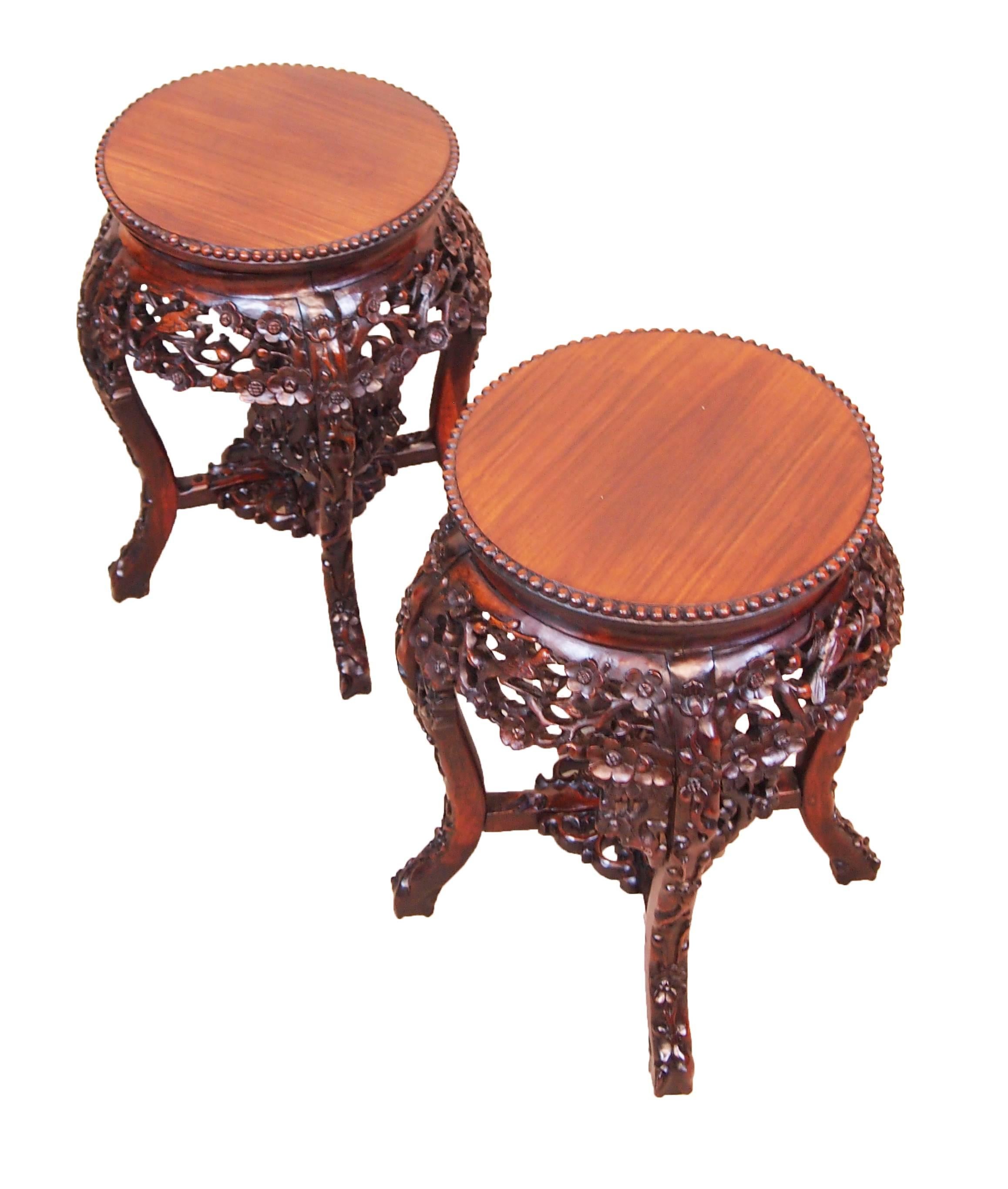 A very attractive and unusual pair of 19th century oriental
Hardwood coffee tables having well figured circular tops
Above profusely carved frieze raised on carved cabriole
Legs united by cross stretcher.