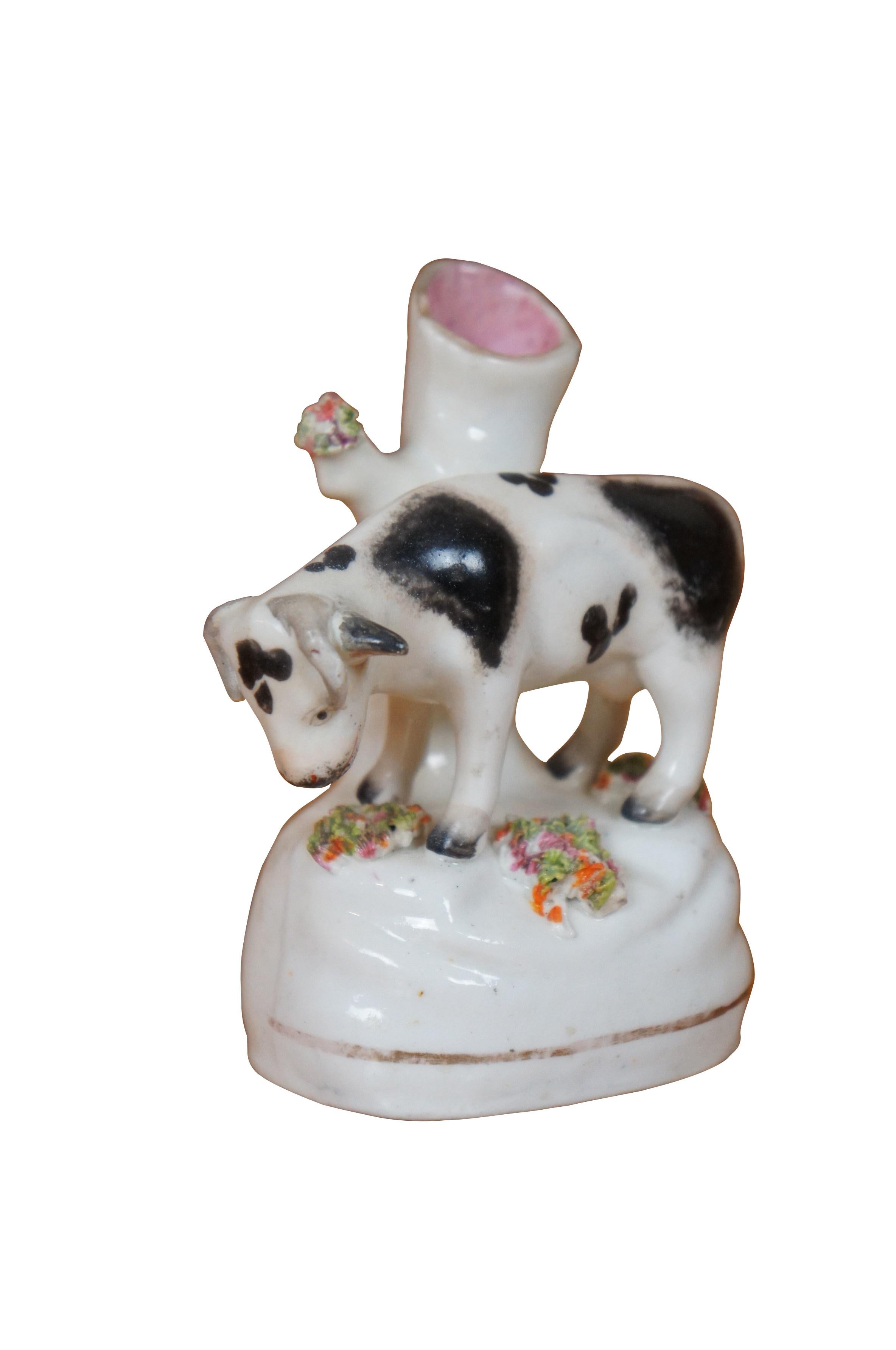 Antique 19th century Staffordshire porcelain cow bud vase / spill vase flatback figurine featuring a cow grazing in the meadow.

Dimensions:
3