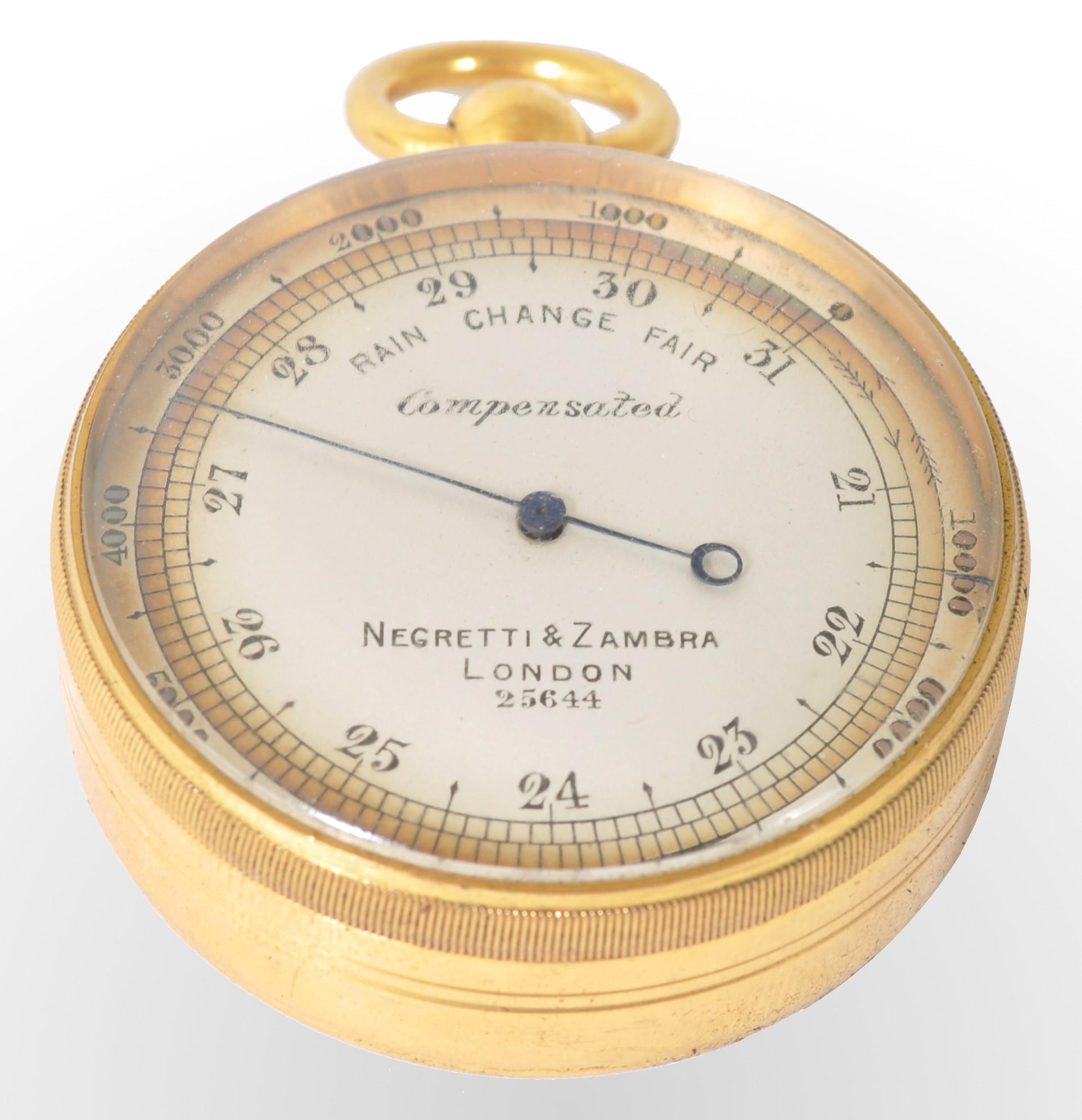 Antique 19th century pocket barometer by Negretti & Zambra of London, circa 1880. The barometer in a gilded metal case with a white enamel dial. The barometer housed in the original outer sharkskin case.