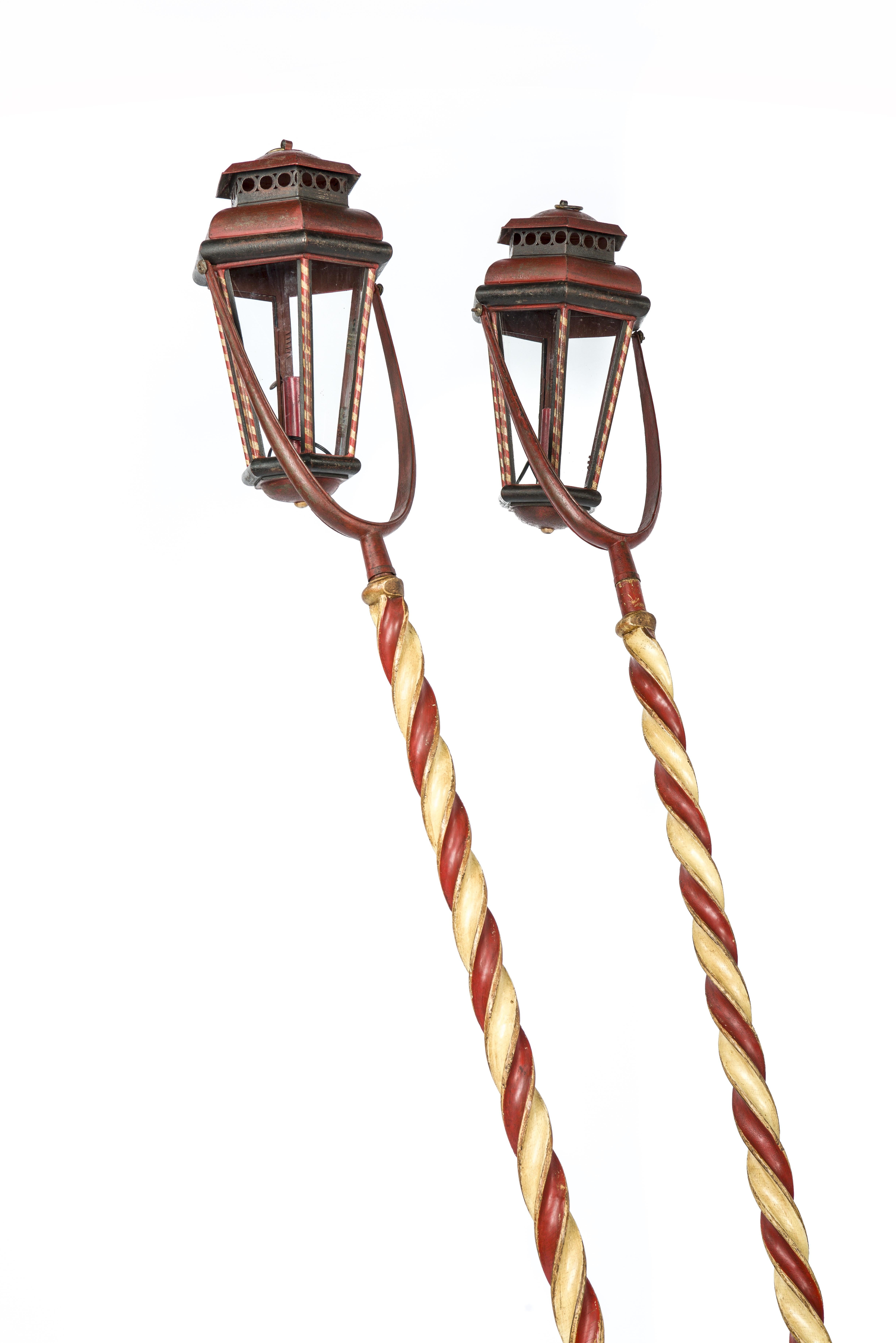 A beautiful pair of Italian or Venetian gondola lanterns with hexagonal metal surrounds were made circa 1850. The lanterns are suspended on swinging metal support in red white and black paint, mounted on red and white barley twisted posts. Dates to