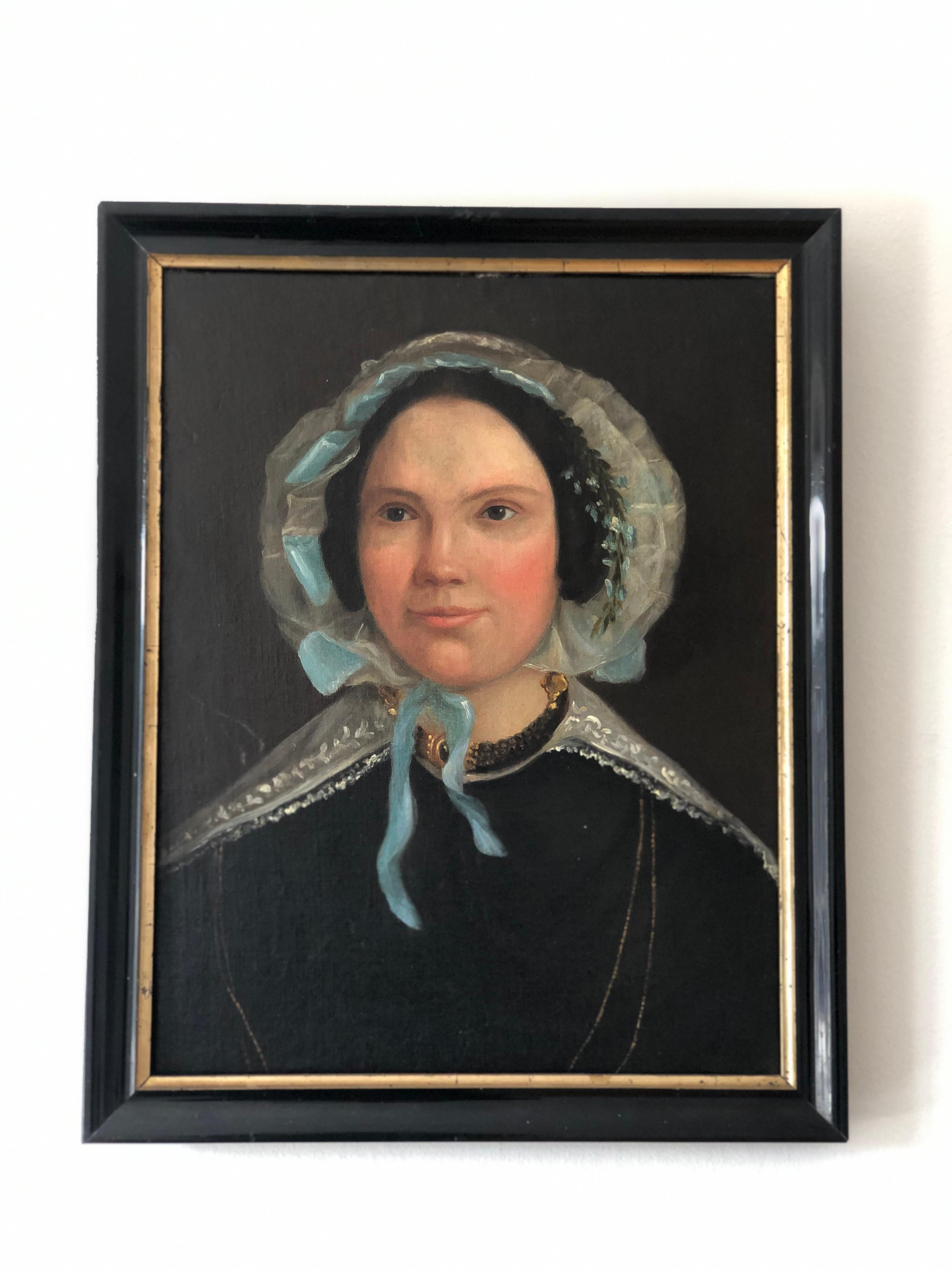 This captivating 1840s portrait painting showcases a Dutch lady dressed in a black embroidered tulle gown, an elegant choice reserved for the upper class. Her long gold earrings, beautiful necklace, and sheer white cap with baby blue flowers and