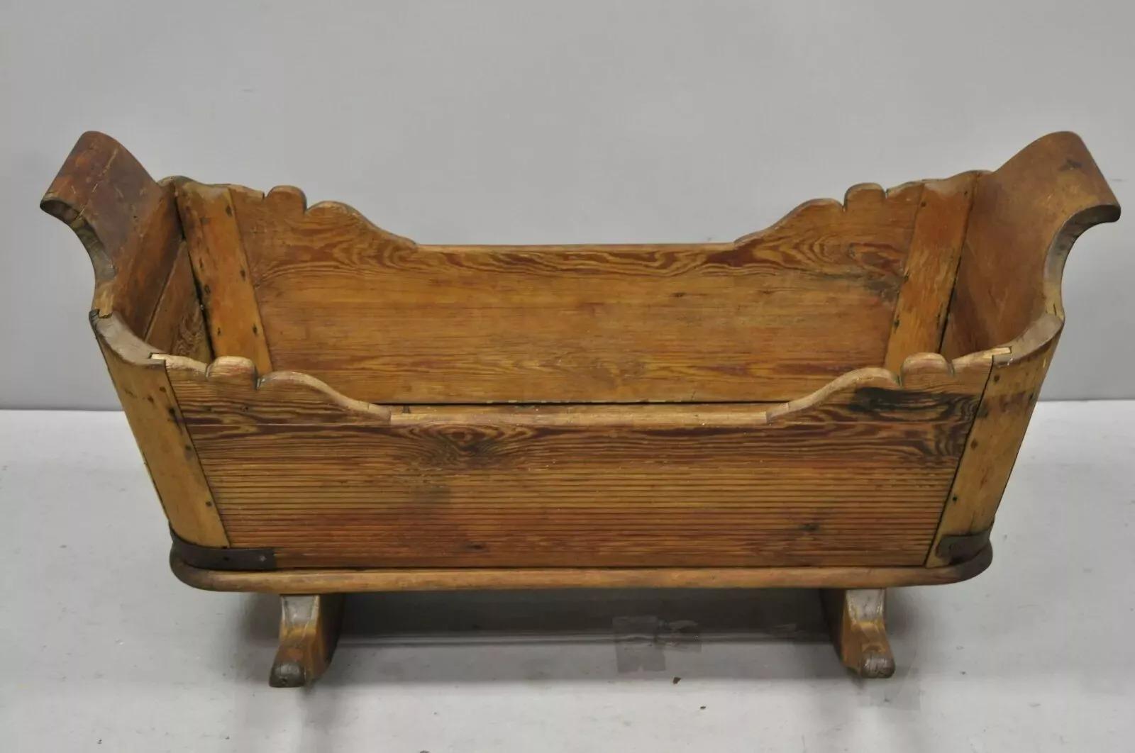 Antique 19th Century Primitive Colonial Carved Wood Baby Rocking Doll Cradle. Circa 19th Century. Item features solid wood construction, beautiful wood grain, nicely carved details, quality American craftsmanship. Measurements: 19.5