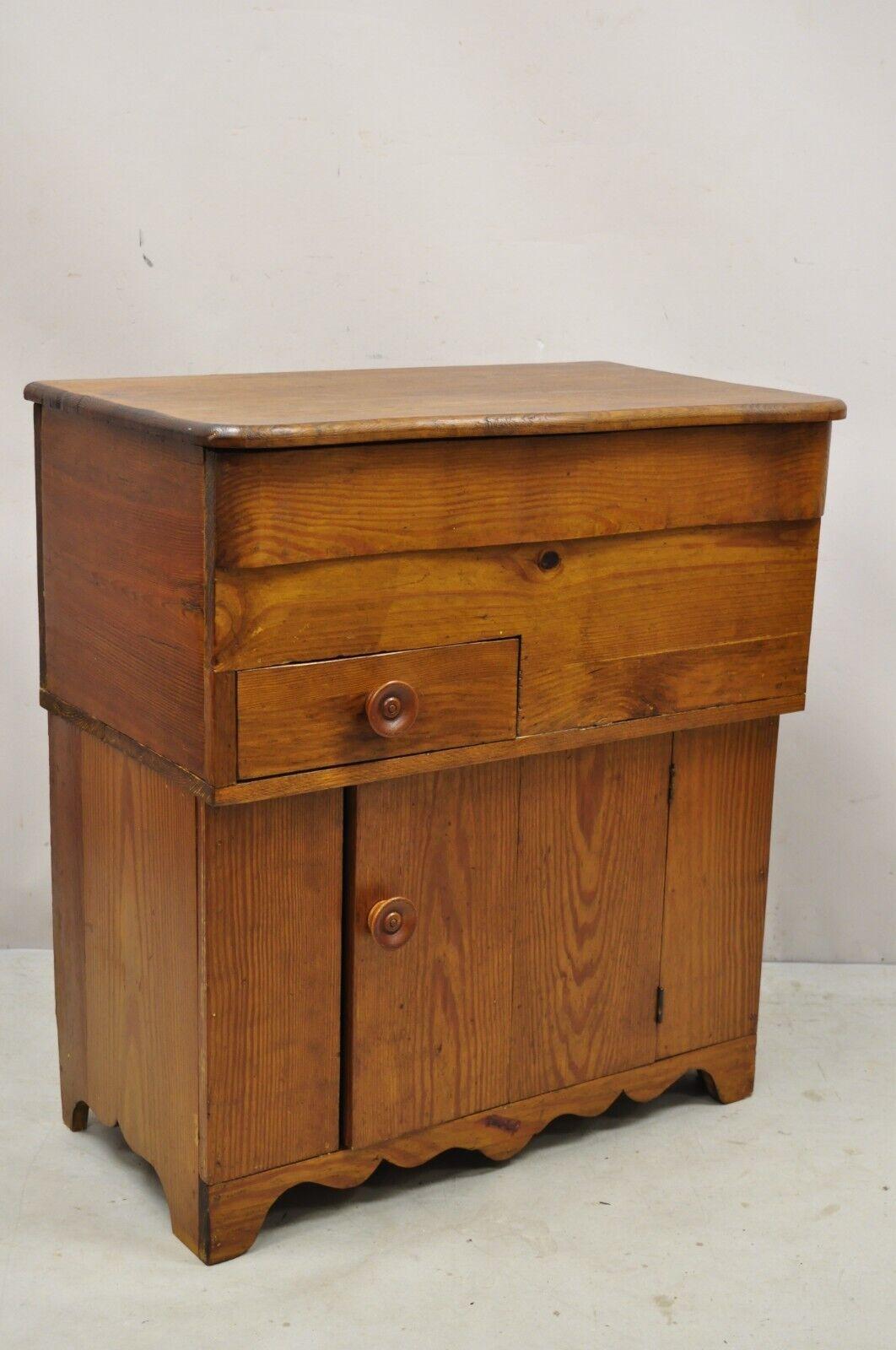 Antique 19th century primitive colonial pine wood flip top washstand cabinet. Item features a flip top, single drawer, single cabinet door, solid wood construction, beautiful wood grain, very nice antique item, great style and form. Circa 19th