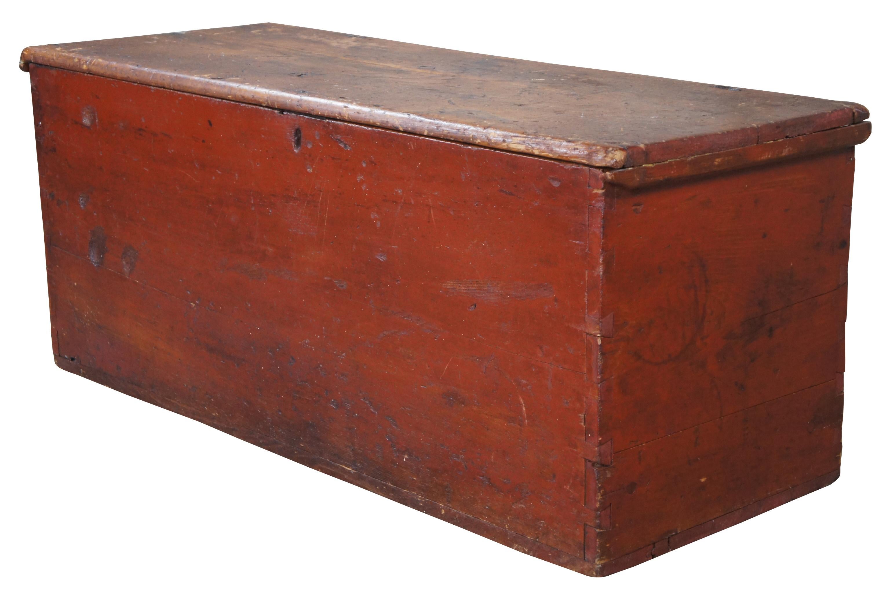 Antique 19th century primitive pine farmhouse blanket / hope chest or toy storage trunk. Made of pine featuring rectangular form painted red exterior, hand dovetailing, forged iron hinges and one interior compartment. Measure: 44