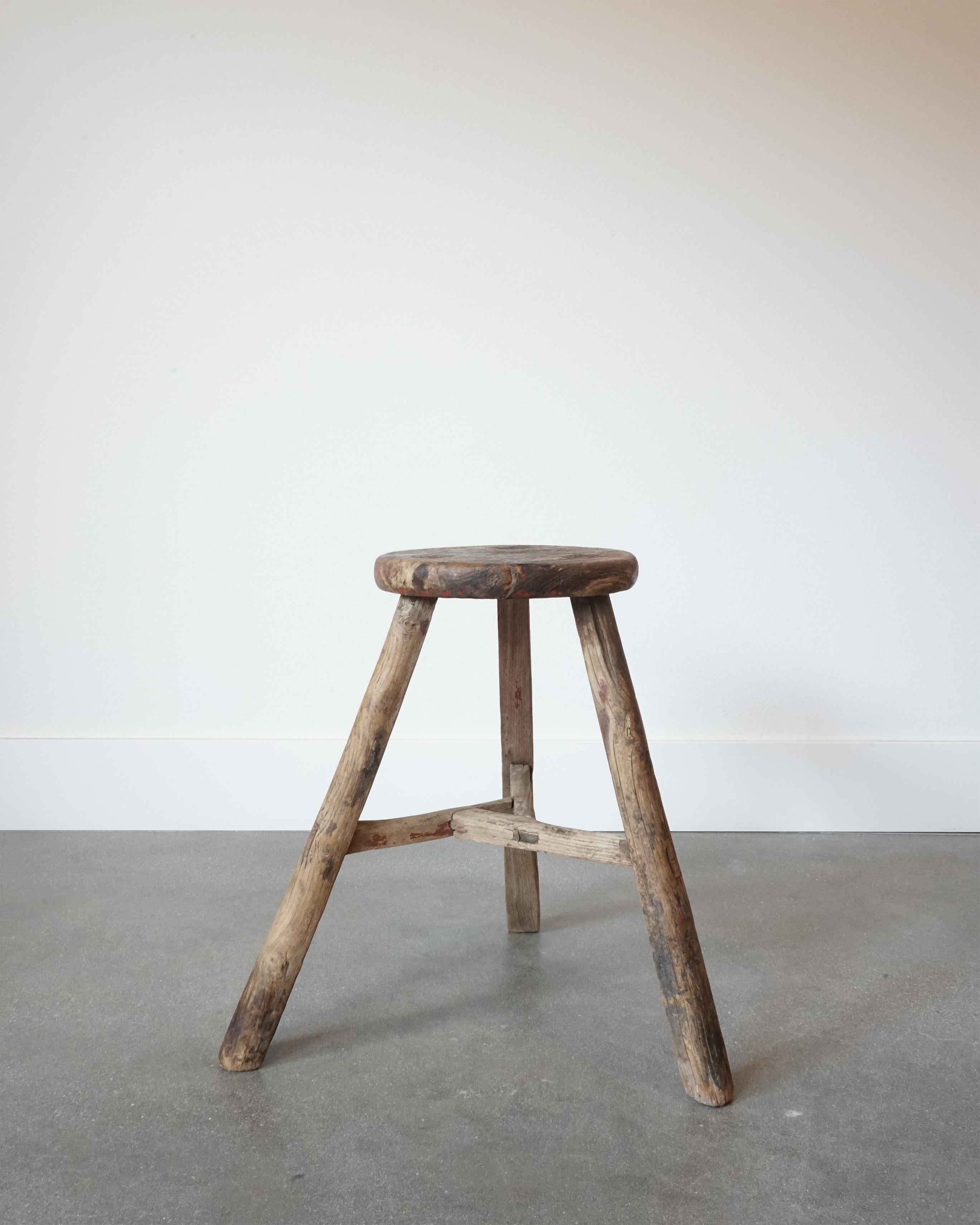 Antique 19th century primitive tripod stool.

Beautiful age showing loss of paint and excellent wear throughout. Sprayed legs with pin and grove construction. The stool is very solid with no wobble, major cracks, etc. 

Excellent side table,