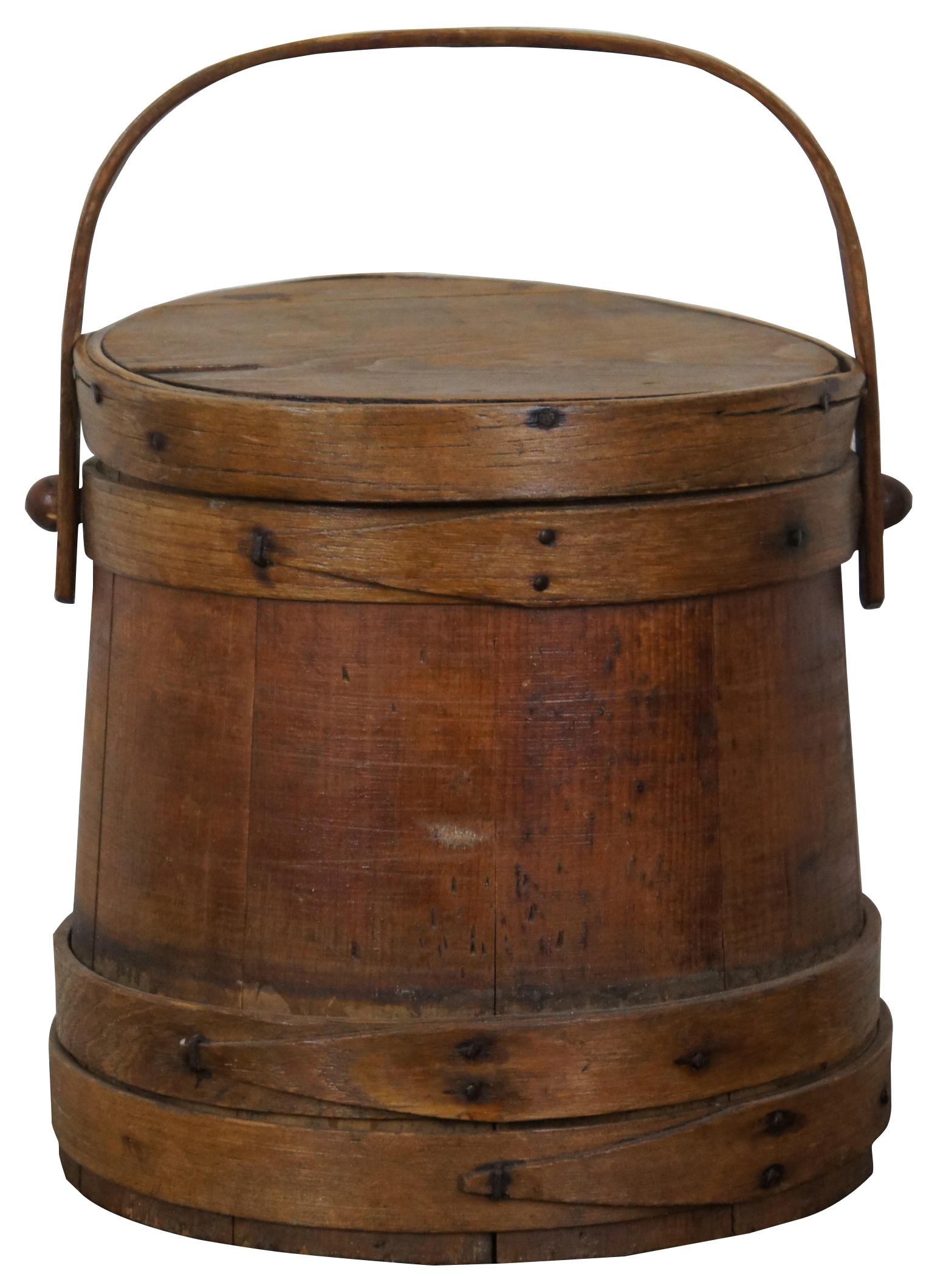 Antique wooden sugar bucket or firkin with rotating handle and lid. Measure: 10”.
  