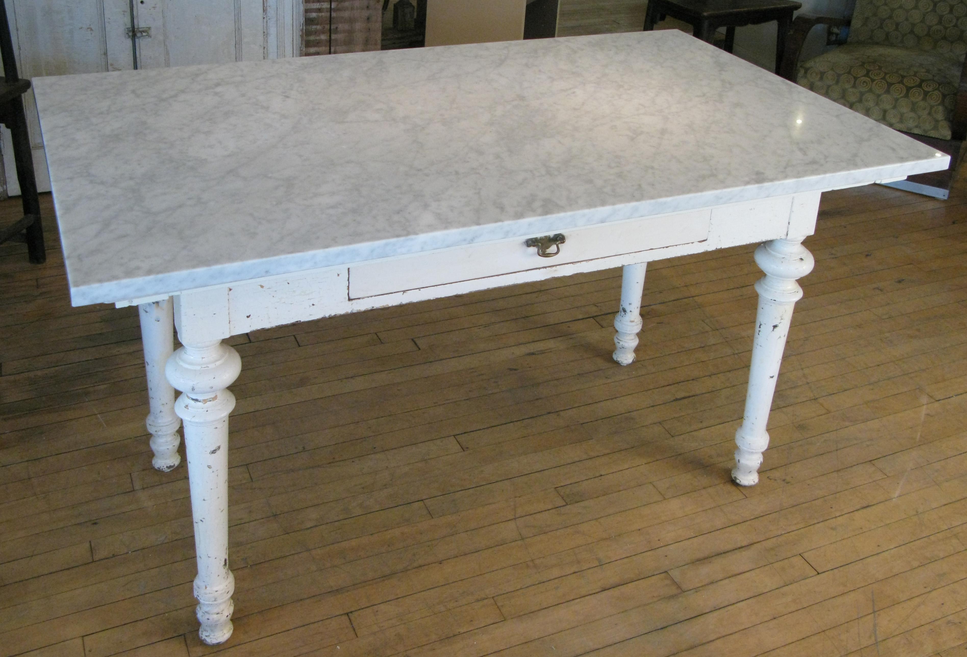 A gorgeous late 19th century painted refectory table with a beautiful Italian Venatino marble top. The table with a single drawer and turned legs, with its original off white painted finish. Fantastic scale and details.
