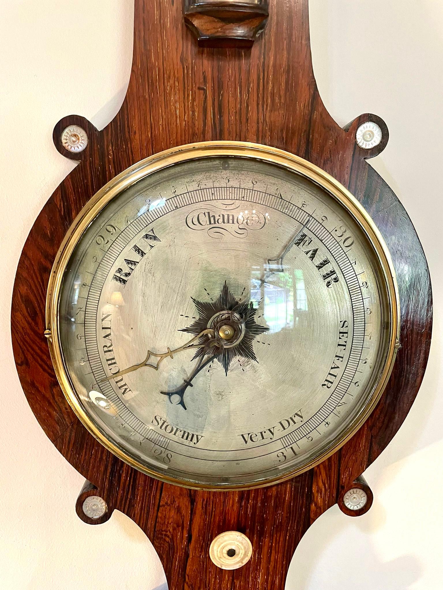 Antique 19th century rosewood banjo barometer having a quality rosewood inlaid Mother of Pearl case with an Onion shaped top, nine inch silvered engraved dial with original hands, a thermometer, fitted hygrometer, glass fronted spirit level and a