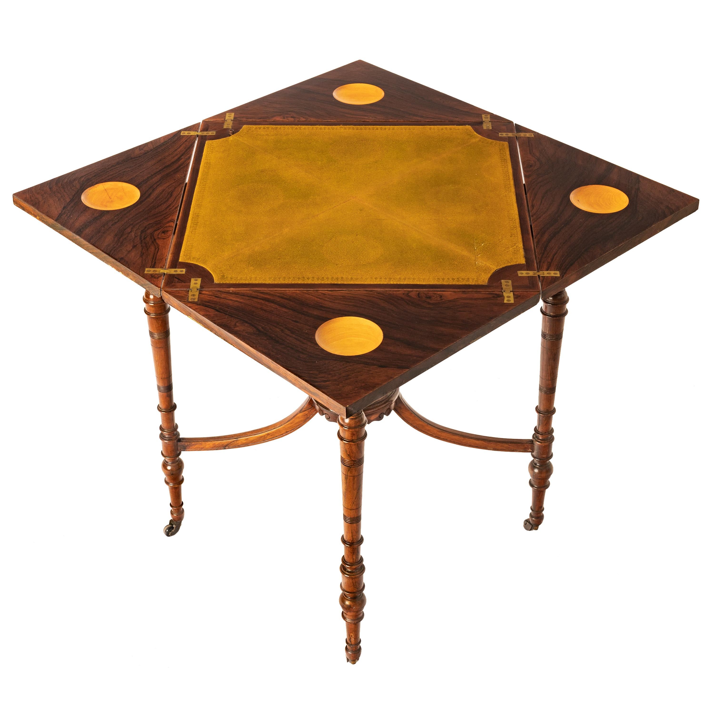 Antique English Edwardian rosewood & marquetry inlaid envelope card table, circa 1890.
The table having a square top with four leaves that are inlaid with floral satinwood marquetry, each leaf is hinged & folds out to to reveal a larger square