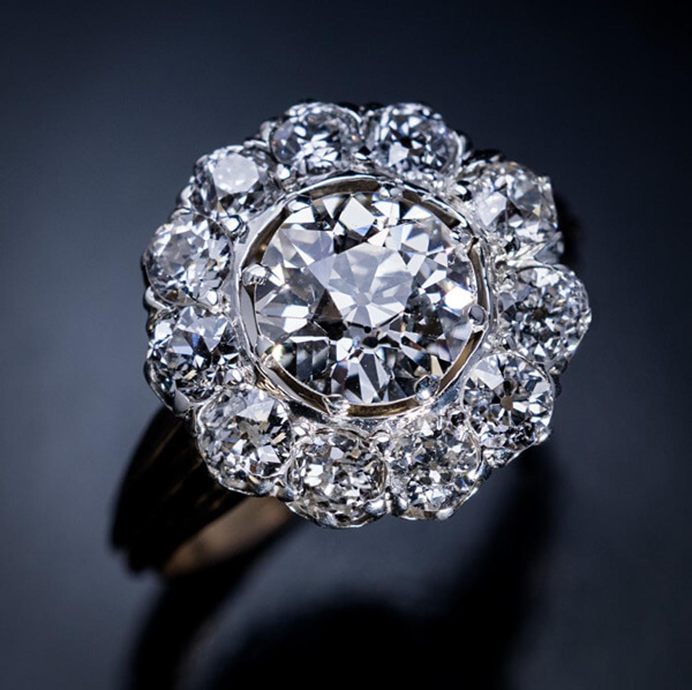 Made in Moscow in the 1880s.

This classic antique diamond cluster ring features a sparkling 1.60 ct old European cut diamond (J color, VS1 clarity). The center stone is encircled by eleven chunky old cut diamonds (G-H color, VS2-SI1 clarity) set in