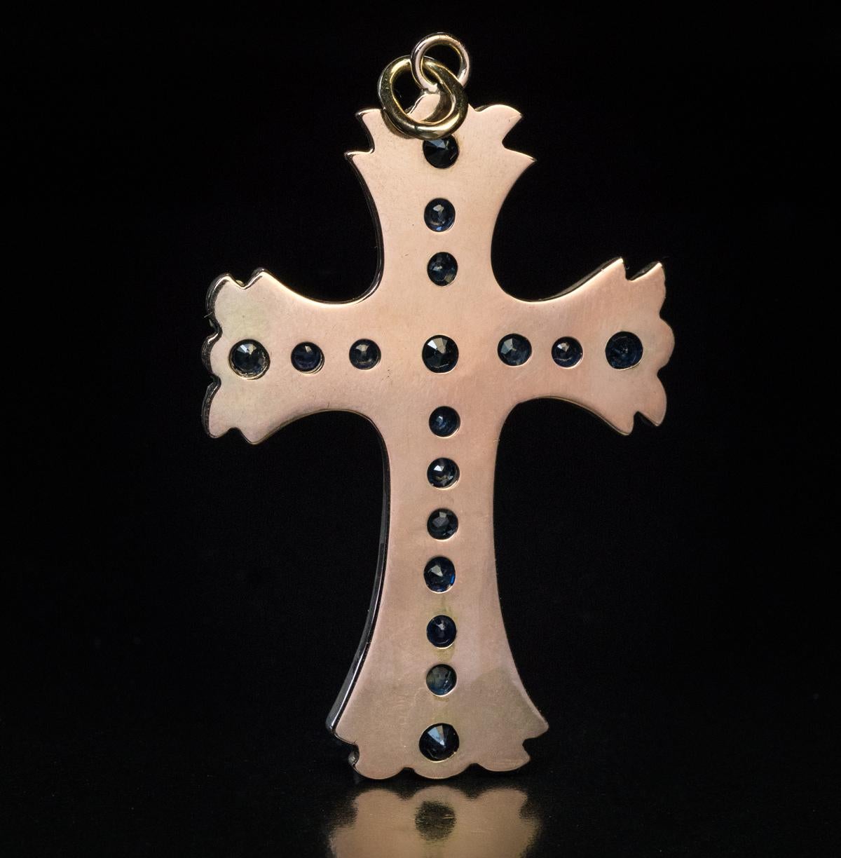 Circa 1890

An antique silver topped 14K gold (front – silver, back – gold) cross pendant is densely set with midnight blue sapphires and old rose cut diamonds.

The cross measures (without suspension ring) 52 x 34 mm (2 x 1 5/16 in.)

Sold without