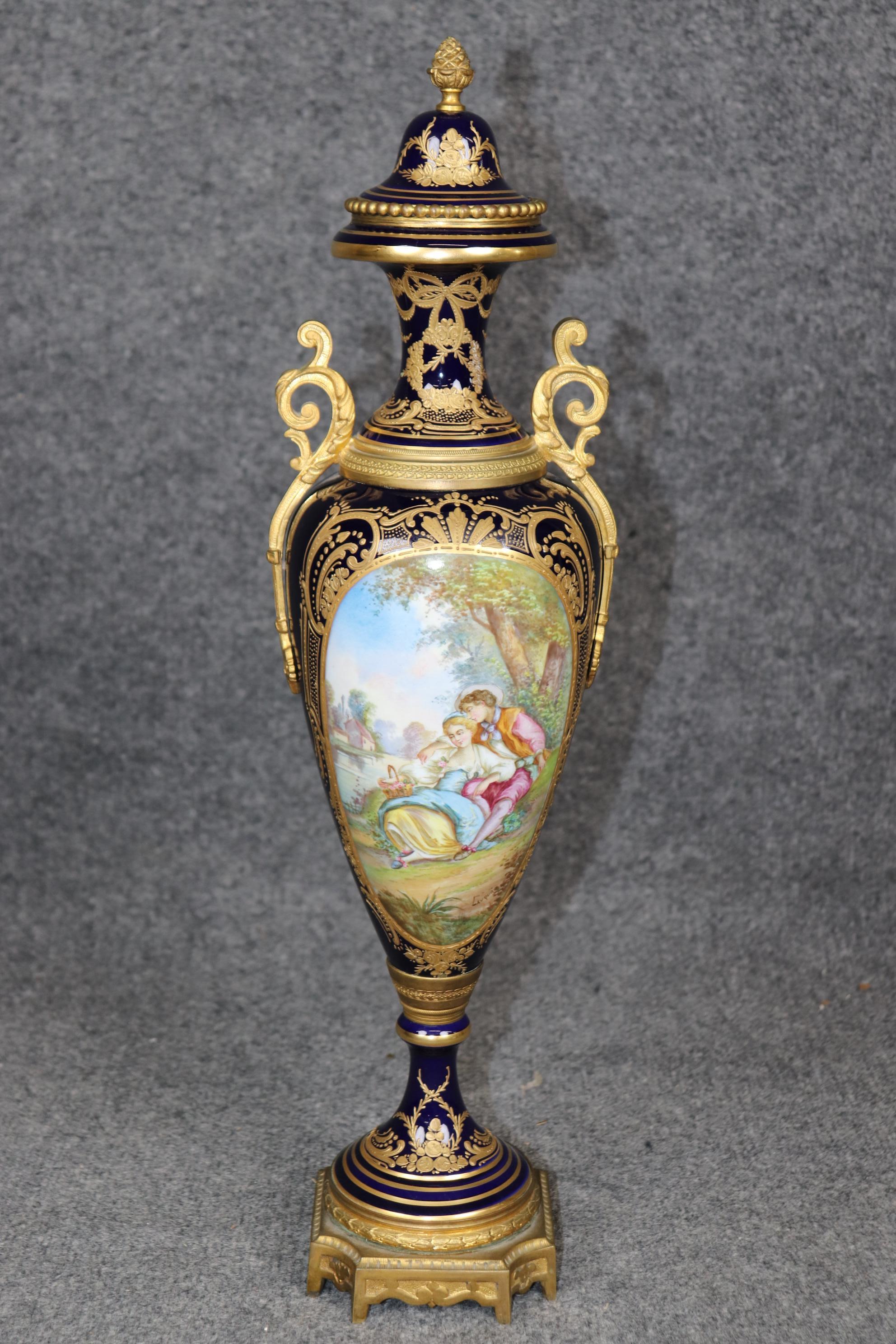 Dimensions - H: 21 1/4 in W: 5 1/2 in D: 5 in 

This Antique 19th Century Sèvres Royal Blue Porcelain Vase Made in France is an exquisite representation of the unparalleled craftsmanship and artistic legacy of the renowned Sèvres porcelain factory.