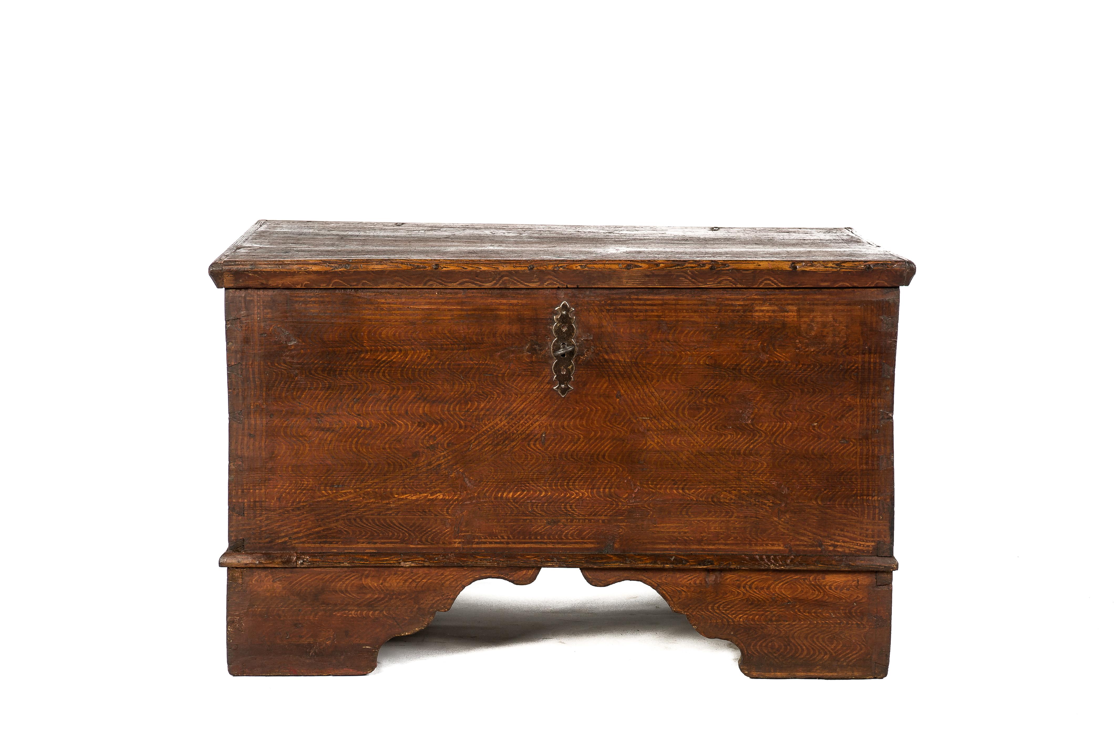 This beautiful trunk or blanket chest was made in Austria and is dated 1888. The brick red decorative wave pattern paint is authentic to the piece. The chest is elevated on bracket feet and is equipped with the original hinges, keyplate, lock, and