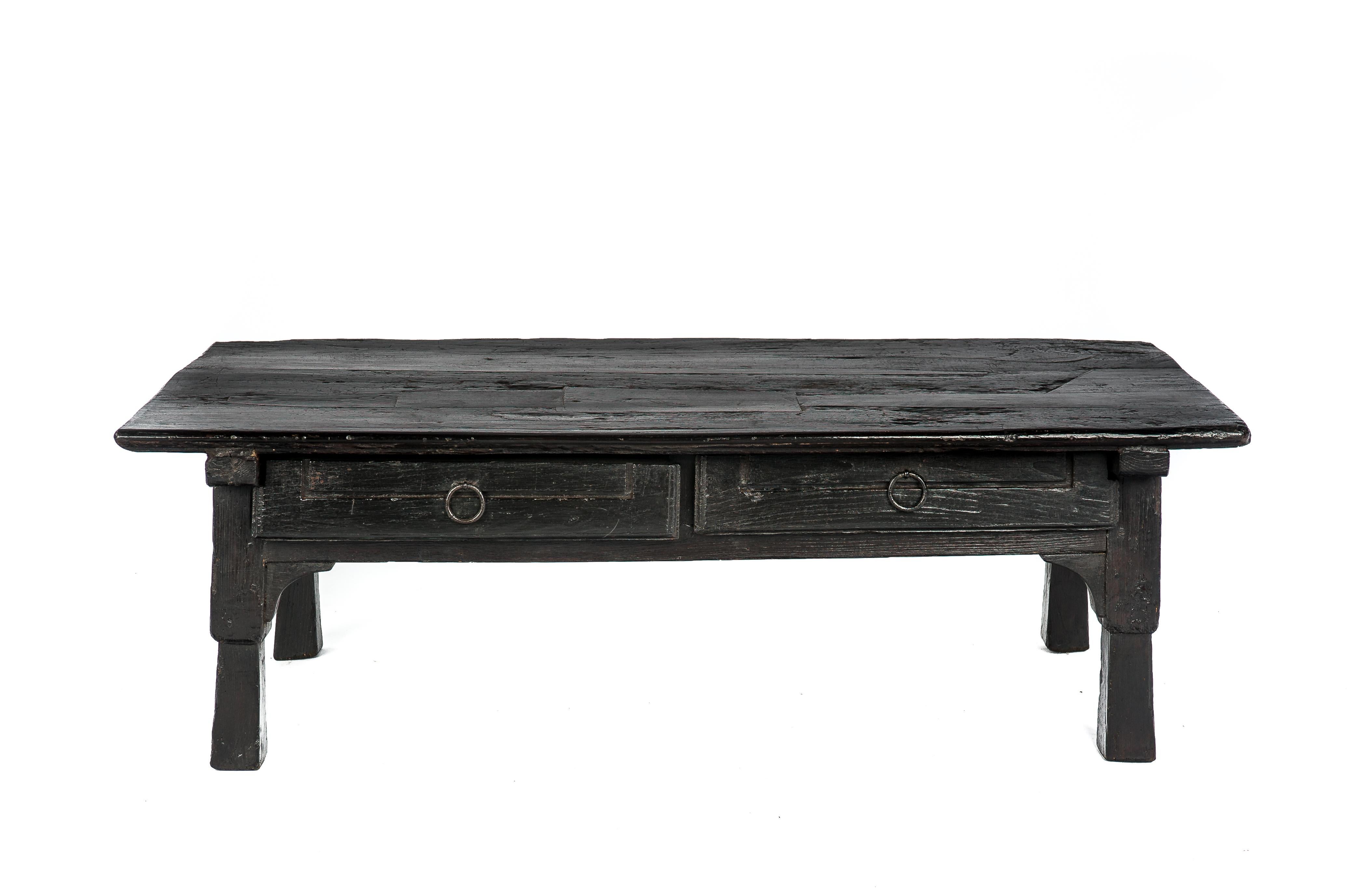 Une belle table basse sombre qui provient d'Espagne, vers 1840. 
La table est entièrement réalisée en bois de châtaignier massif et porte les marques de nombreuses années d'utilisation intensive. La table a un plateau épais avec de nombreux inserts