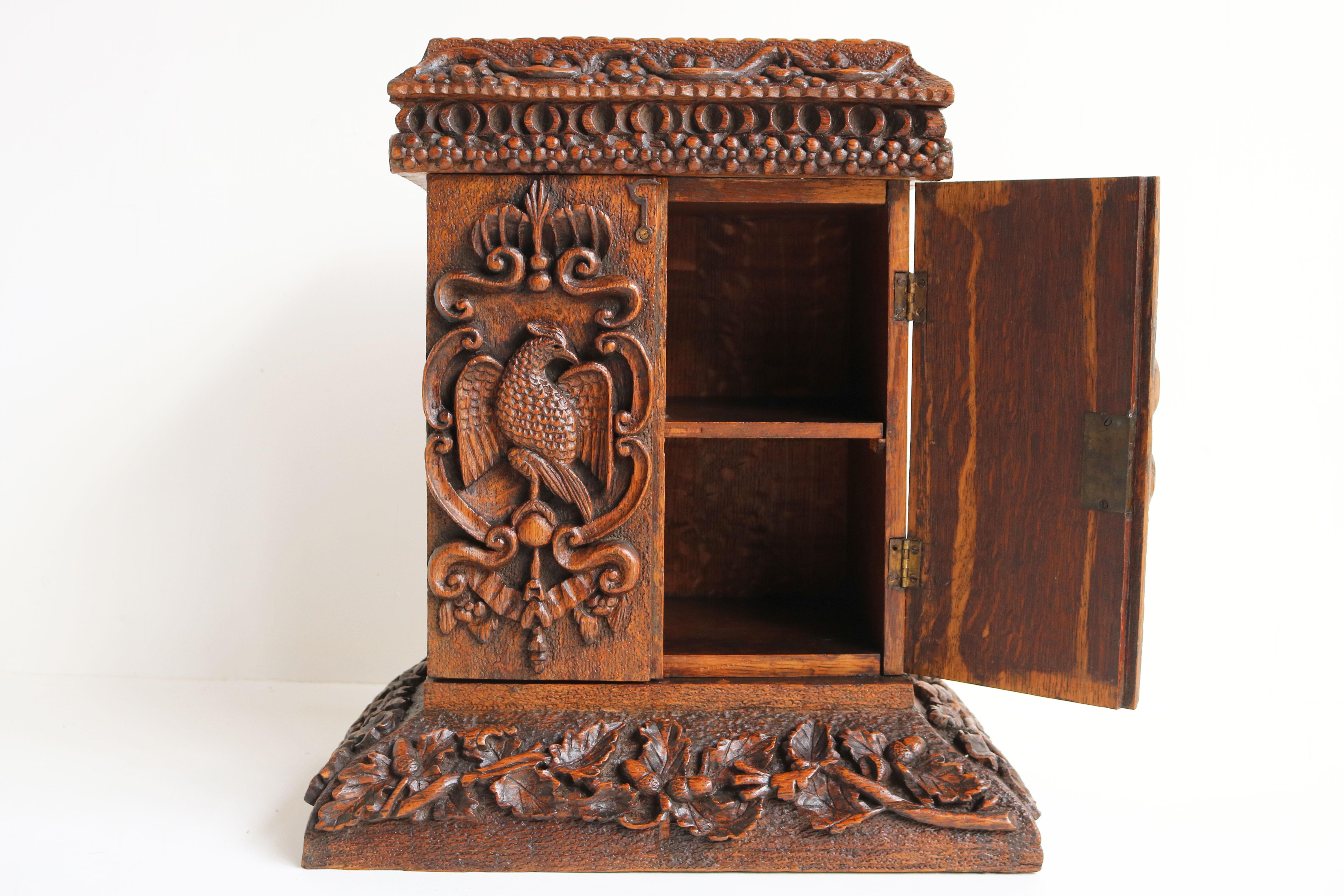 Stunning 19th century Swiss black forest hanging cabinet / small cabinet carved from solid oak. 
Superb Black Forest cabinet with floral carvings displaying leaves & acorns. The doors are decorated with 2 impressive Birds. 
The cabinet is made