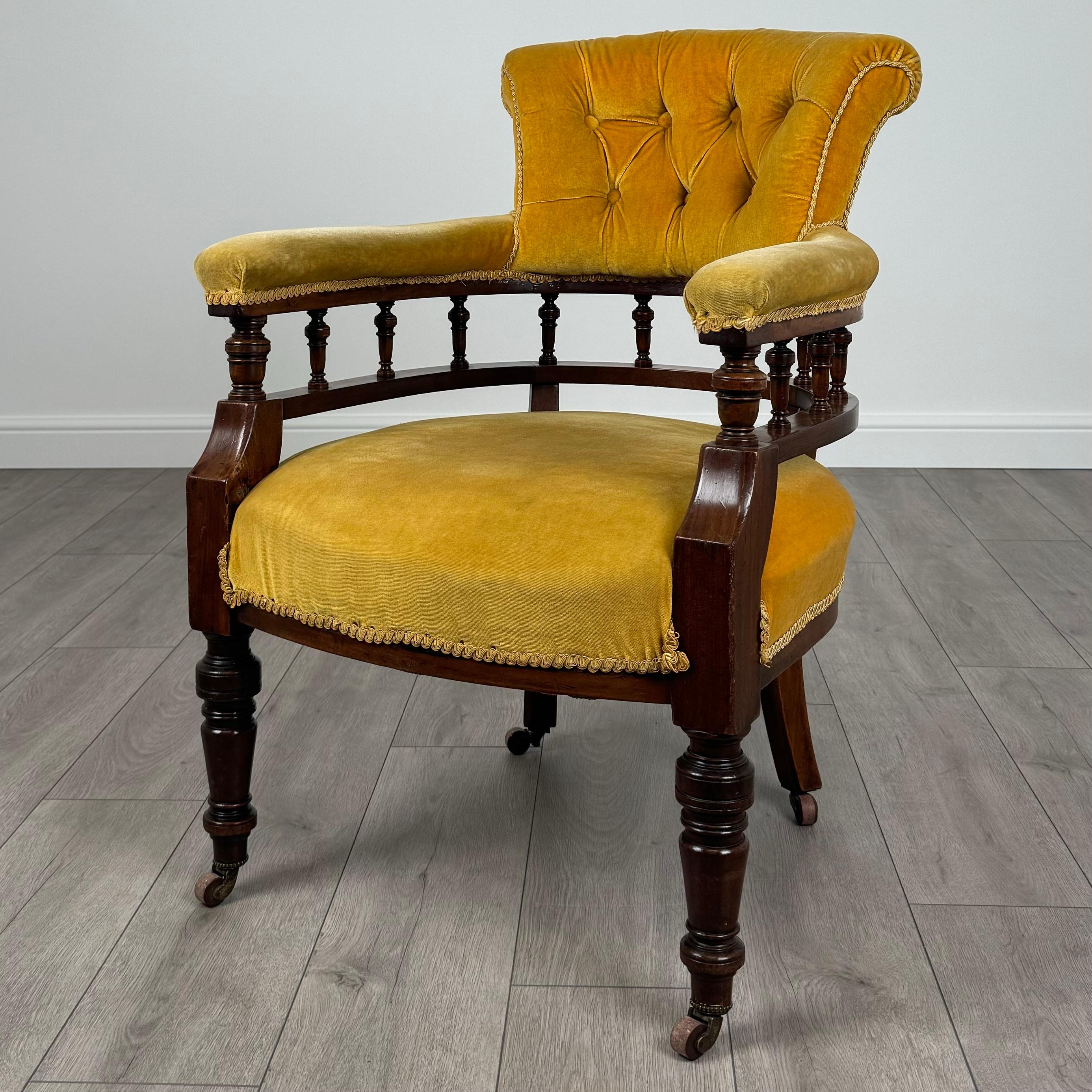 This antique 19th-century tub chair is a stunning example of Victorian craftsmanship, featuring a beautiful mahogany frame that exudes quality and elegance. 
The chair stands on turned legs with casters, making it both stylish and practical. The