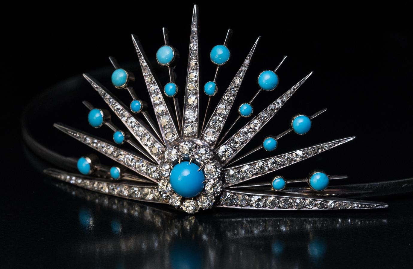 Circa 1880

This elegant Victorian era sunburst tiara is finely crafted in gold and silver. The tiara is embellished with vivid blue turquoise cabochons and bright white old mine cut diamonds of good quality (F-G-H color, VS2-SI2 clarity).

The