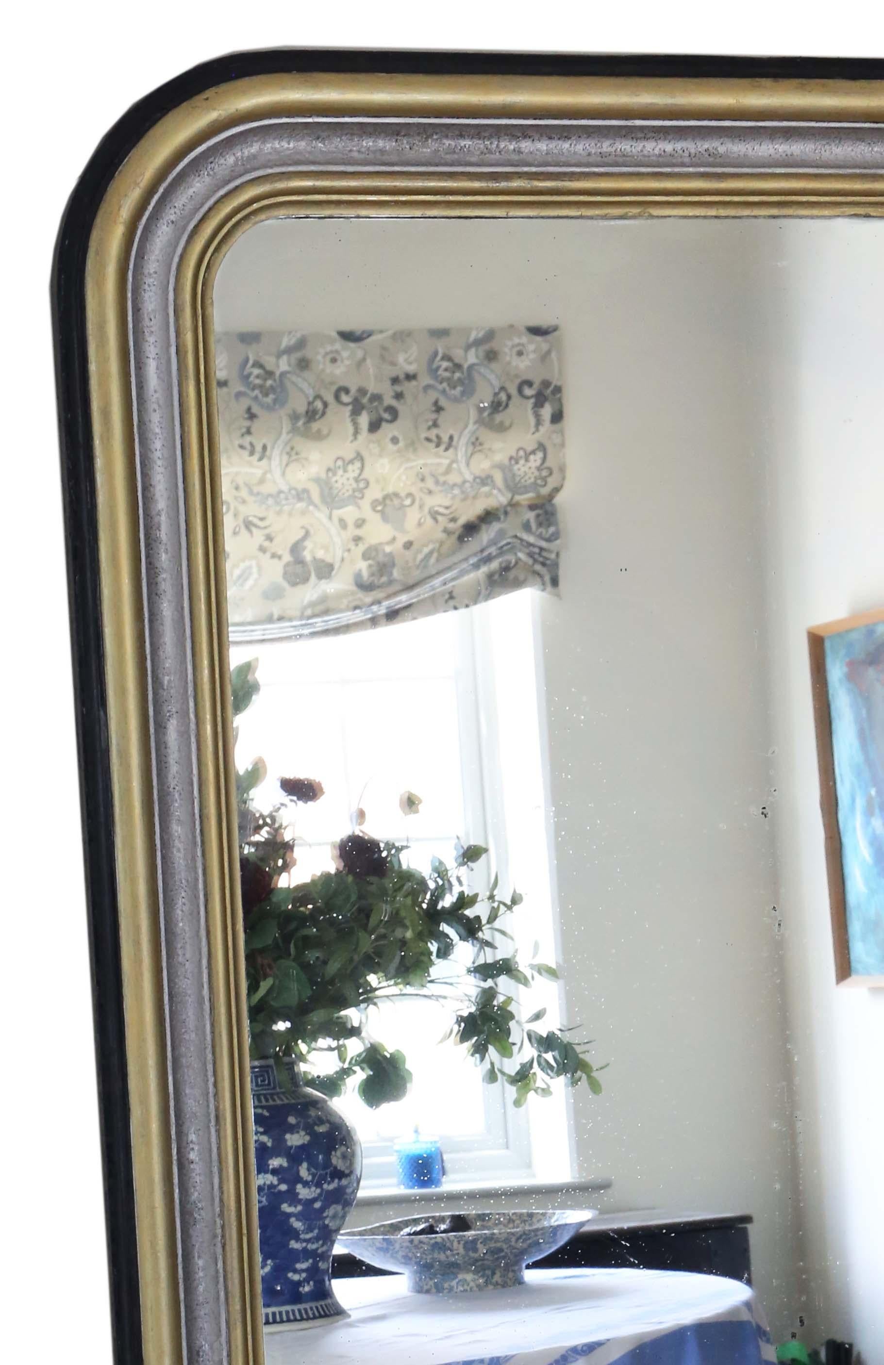 Antique 19th century very large quality ebonized silver and gilt floor wall overmantle mirror.

An impressive rare find, that would look amazing in the right location. No loose joints or woodworm.

The original mirrored glass has light