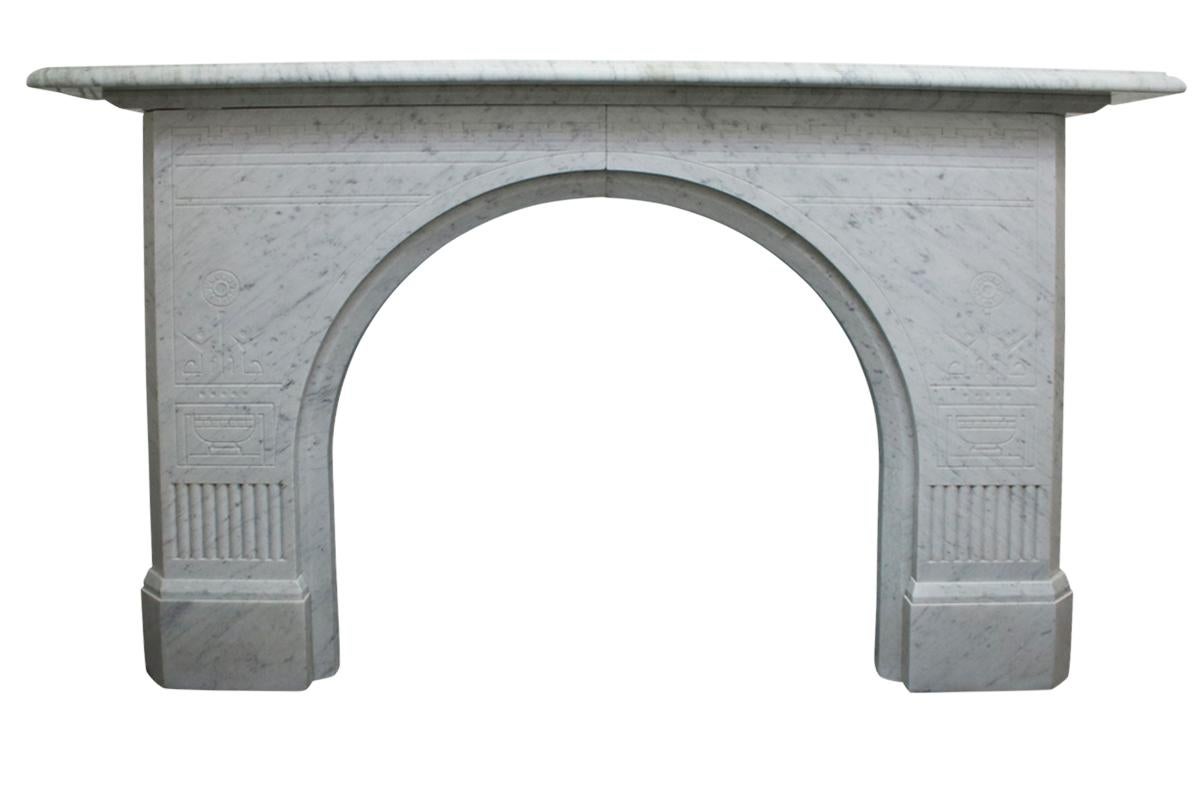 Unusual antique Victorian Carrara white marble fireplace with an arched aperture and fine aesthetic detail, circa 1870.