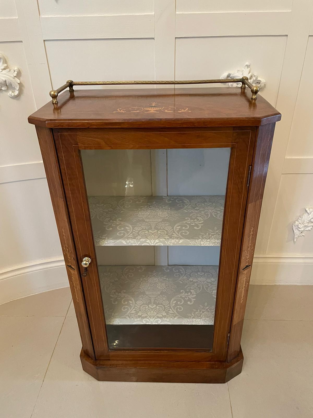 Quality 19th century antique Victorian burr walnut inlaid music cabinet having an appealing original brass gallery, a beautiful quality burr walnut top with urn and stringing boxwood inlay, one glazed door opening to reveal two shelves. It features
