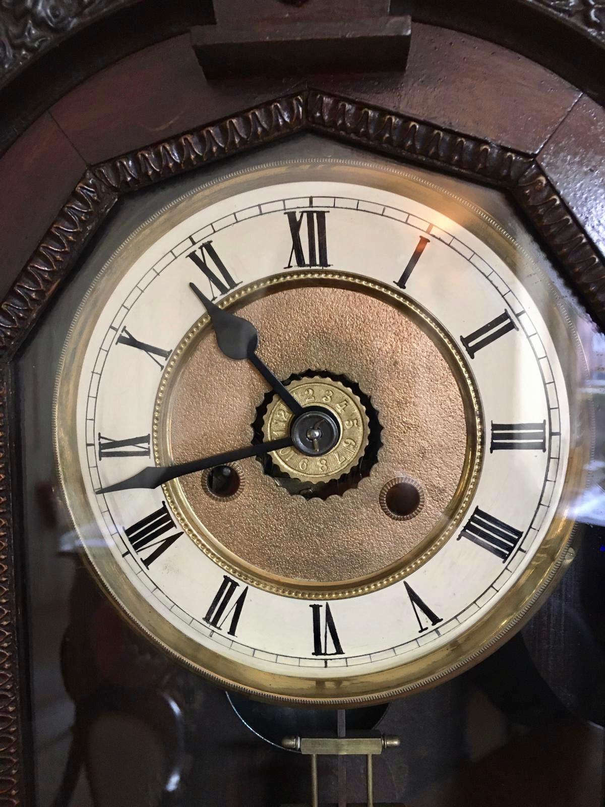 Antique 19th century Victorian carved ornate mantel clock with an 8 day striking movement, original hands and unusual pendulum. The case having seven turned finials, turned column supports standing on a carved plinth base. In good working order with
