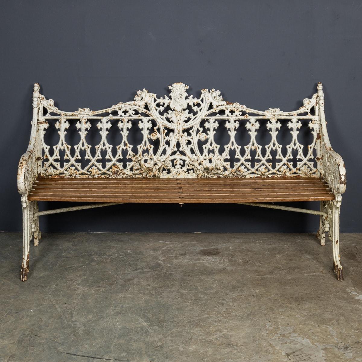 Antique 19th Century Victorian park bench, crafted with cast iron and wood. It features elegantly scrolled arms and legs painted in a white finish. The bench is structurally sound and perfect for any outdoor setting.

We offer complimentary shipping