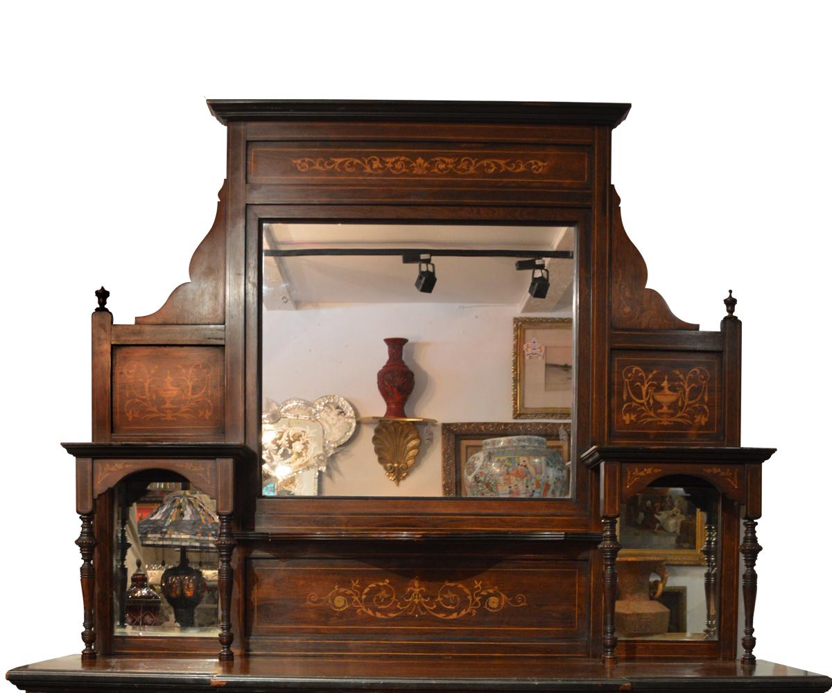 We proudly offer this exquisite English 19th century walnut credenza which features marquetry (inlaid wood) accents along with four mirrors in three different shapes. The fourth mirror is inset in the front lower door and trimmed with molding. This